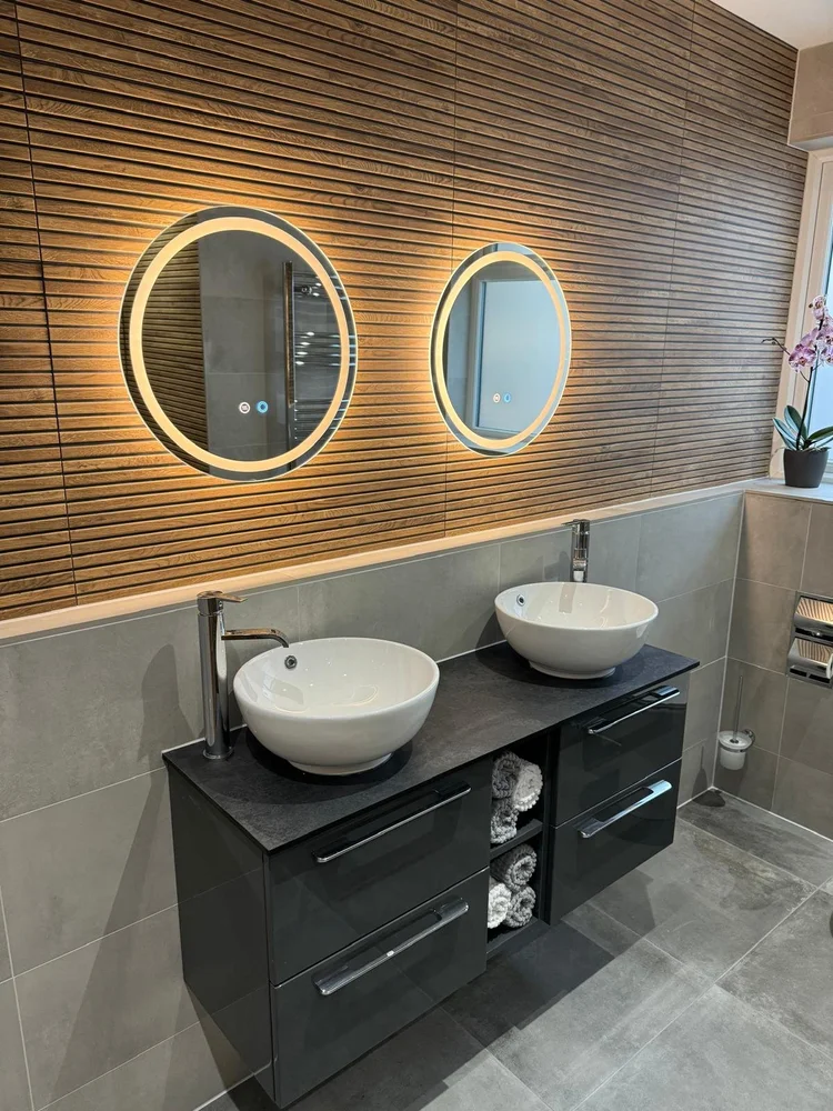Double vanity unit with wood slat feature wall and dual LED backlit mirrors — bathroom installation Nottingham