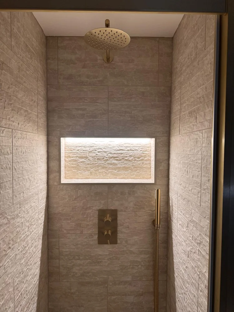 Stone-texture tiled shower with ceiling rainfall head and illuminated wall niche — bathroom installation Nottingham
