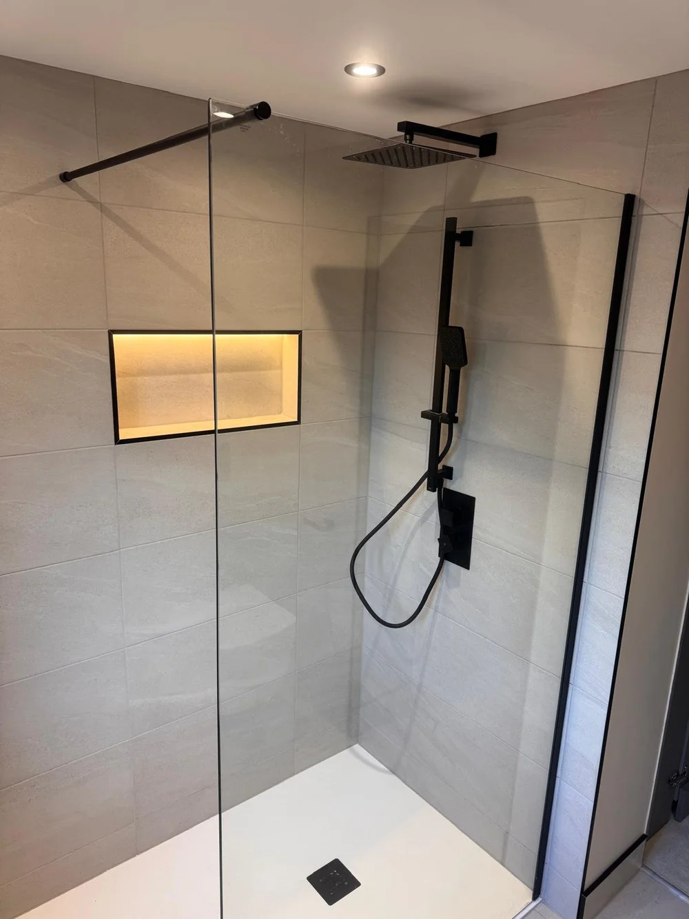 Wet room with grey tiles and black fittings - M.R. Pro Bathrooms Nottingham