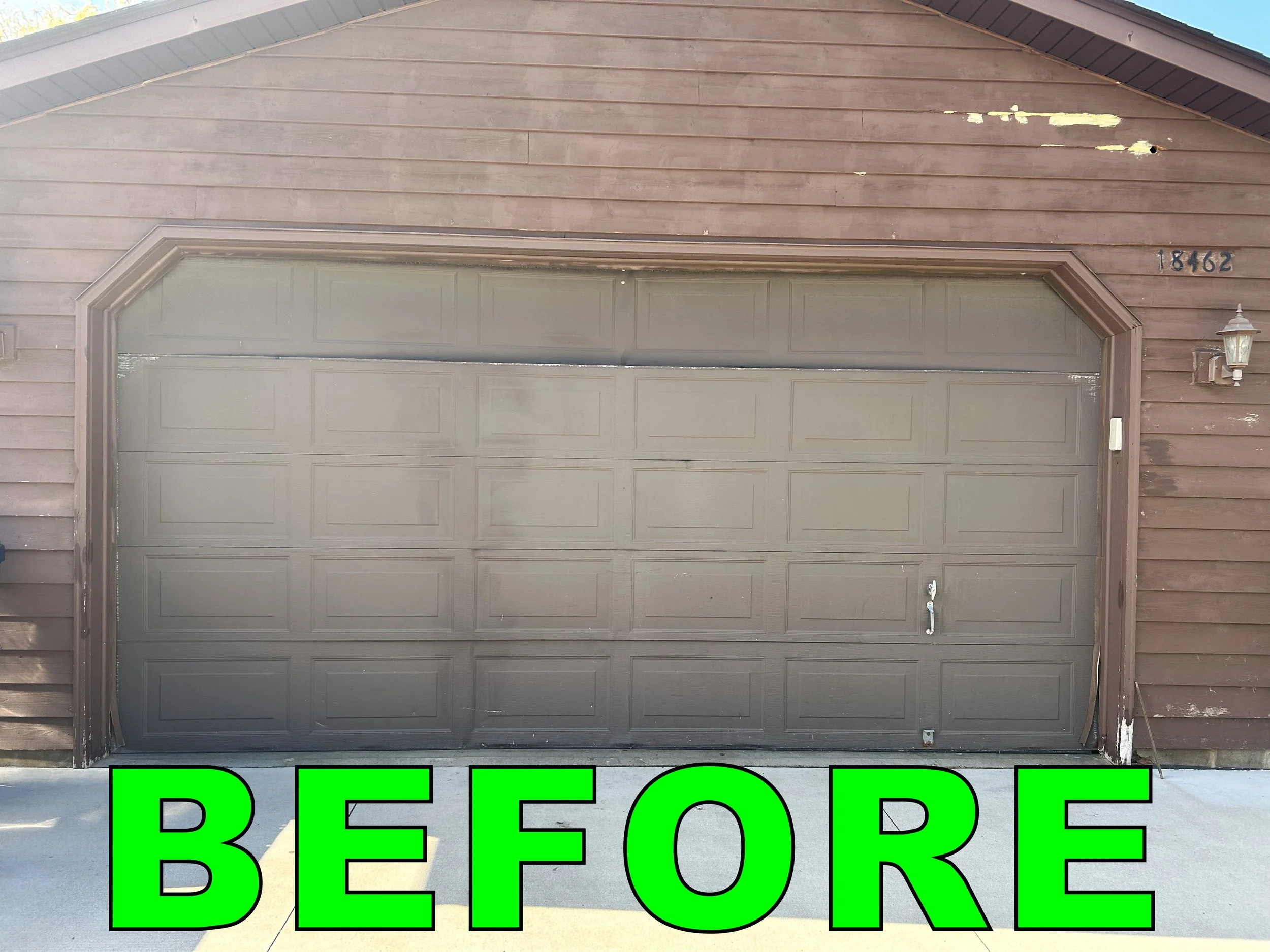 Front view of a gray garage door with house number 18462 on a wooden house exterior. Large green text at the bottom says 'BEFORE'.