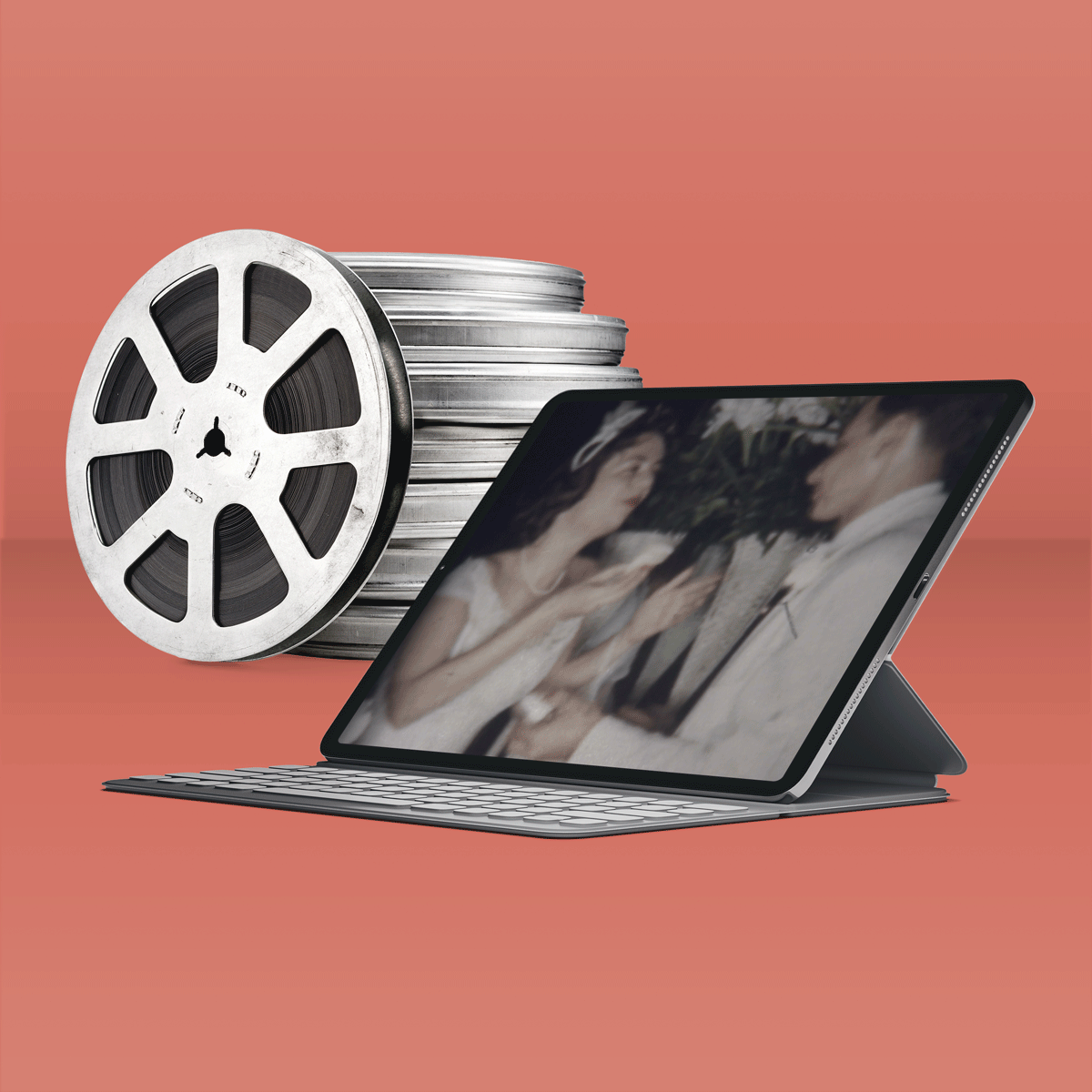 Old reels stacked in the background with an iPad actively playing movie in the screen.