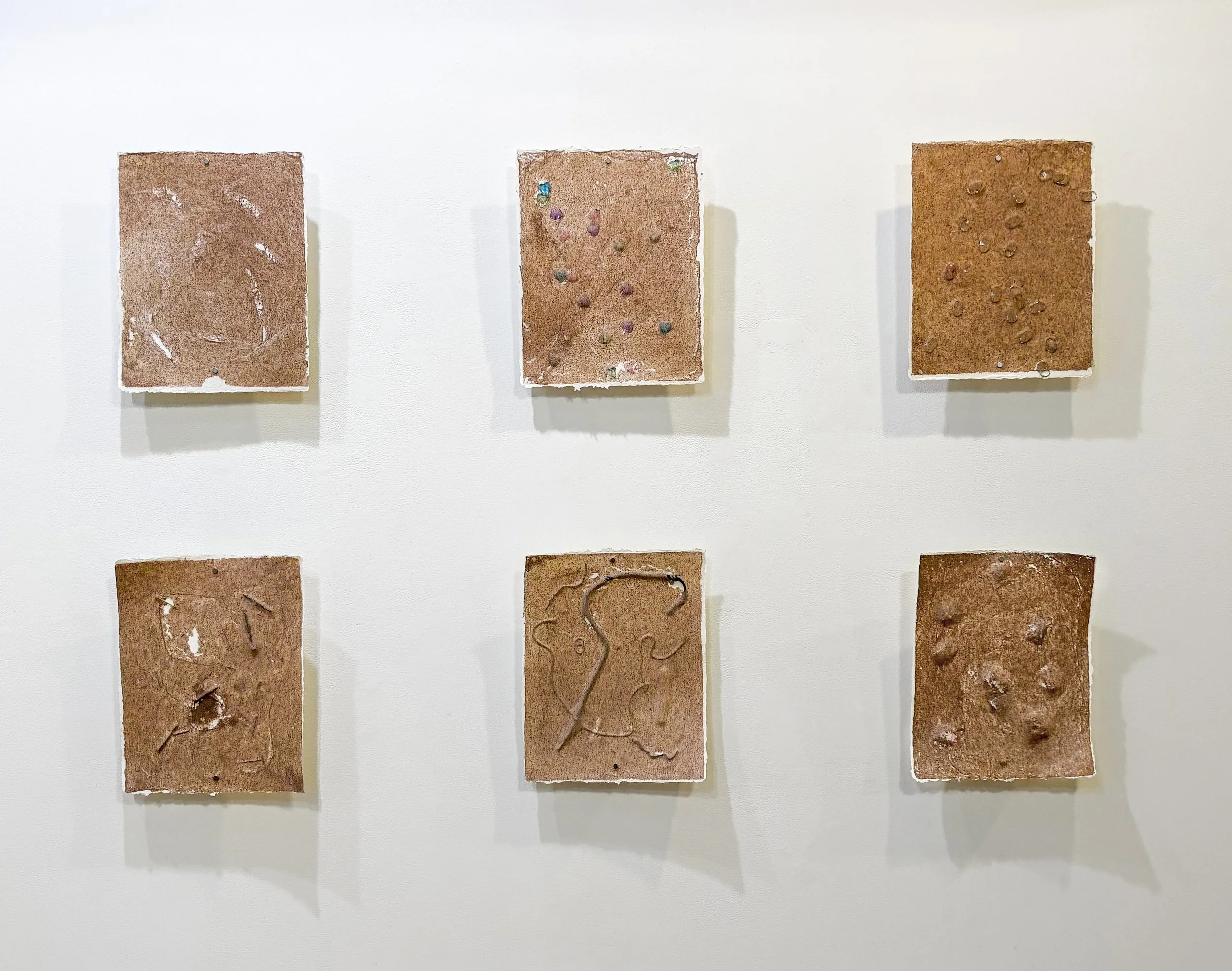 Site Maps, handmade paper from cattails and paper trash with found objects, 9 x 12" each, 2024