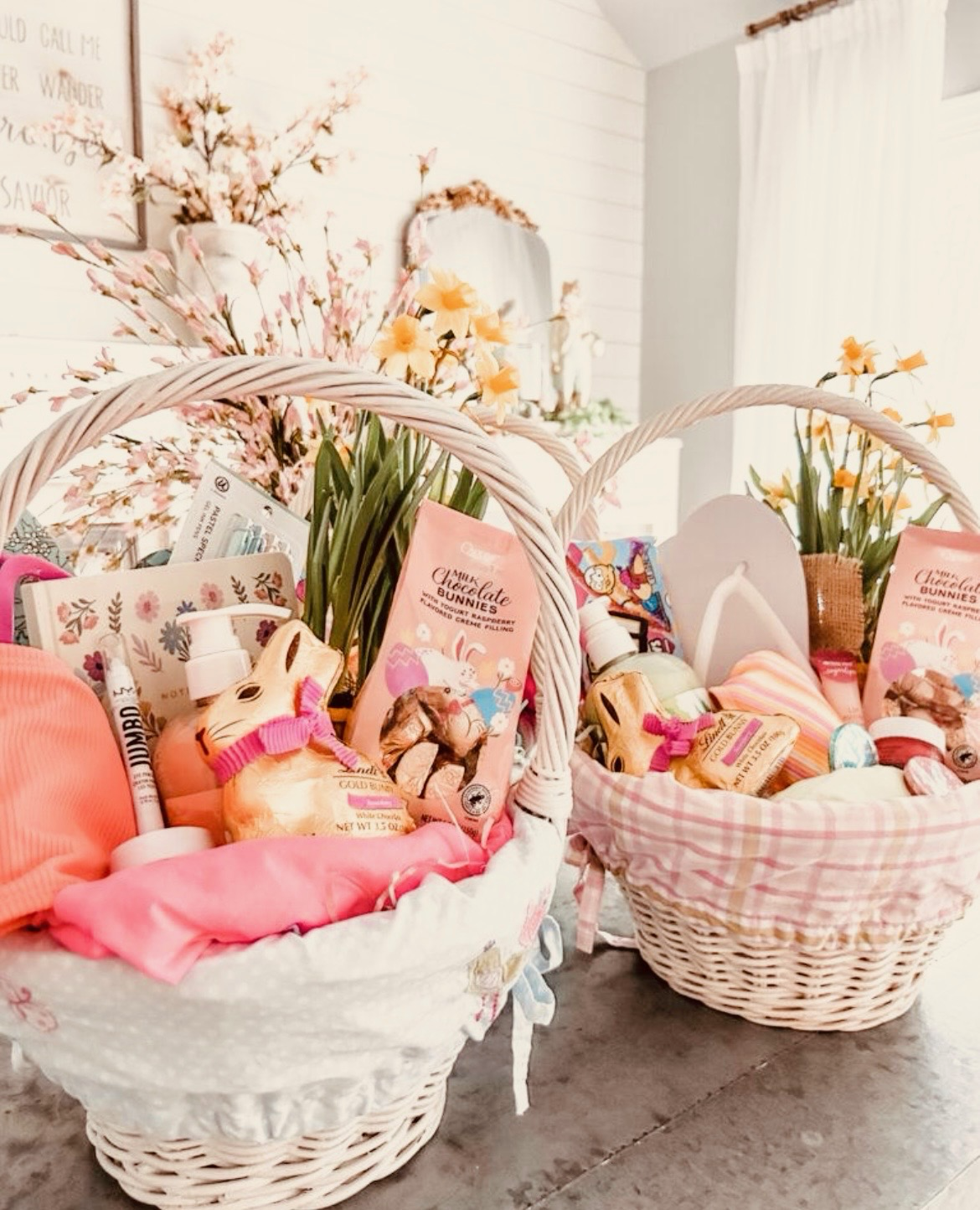 Two white wicker baskets created in Sandpoint, Idaho filled with Easter-themed gifts.  Perfect gift for any celebration, birthday, holiday, or event.