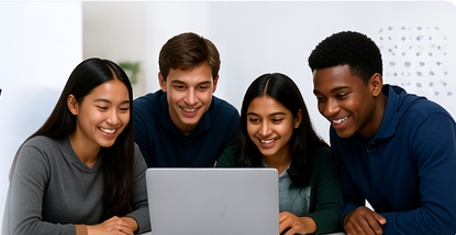 Four young adults gathered around a laptop, smiling and looking at the screen together.