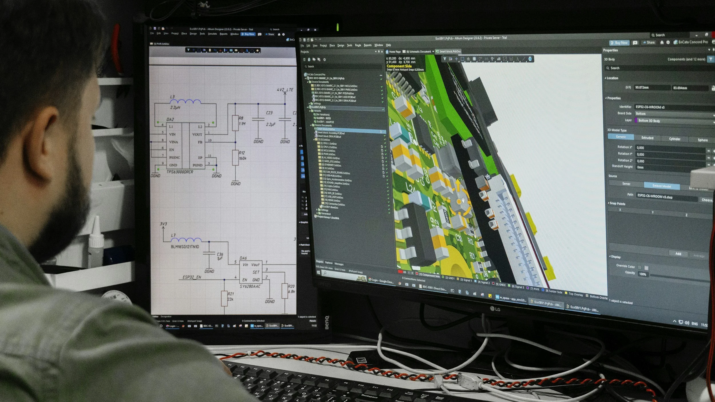 Persona trabajando en diseño de circuito en dos pantallas de computadora, una con esquema eléctrico y otra con modelo 3D de circuito electrónico.