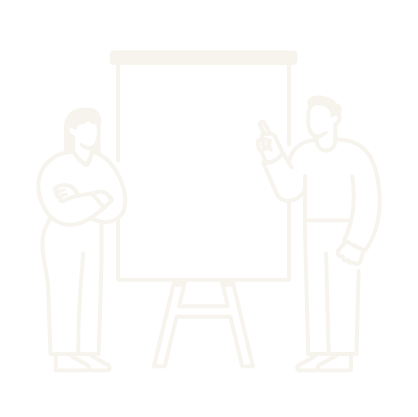 Two people standing beside a blank flip chart or whiteboard, with one person pointing at it.
