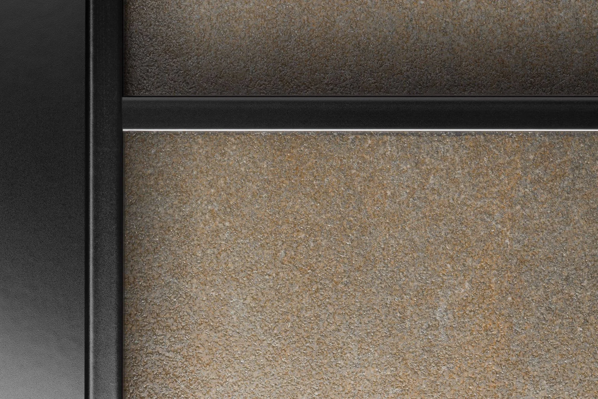 Close-up of textured beige and brown surfaces with a black metal edge.