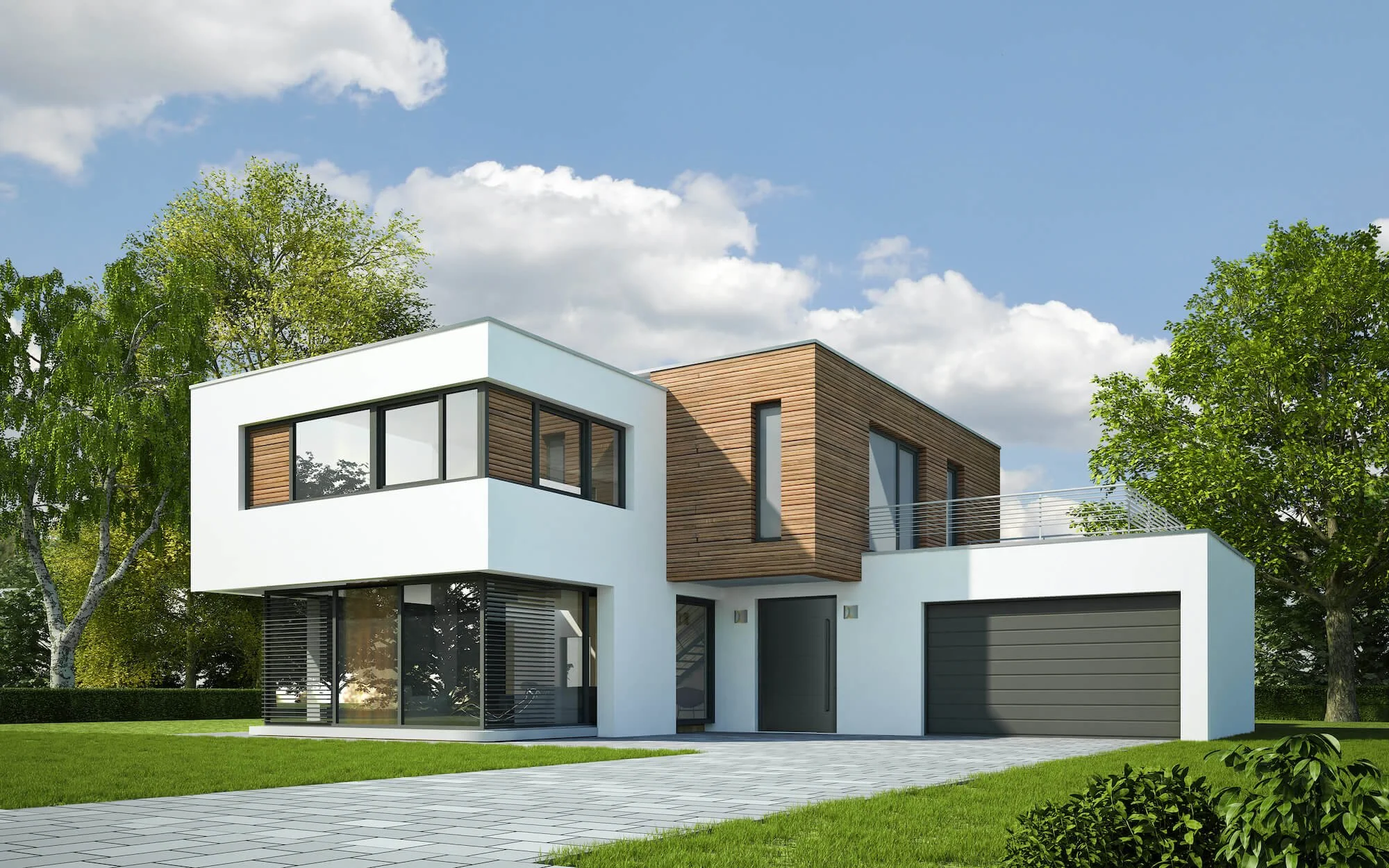 Modern two-story house with white and wood exterior, large windows, and a garage, surrounded by green trees and lawn under a blue sky.