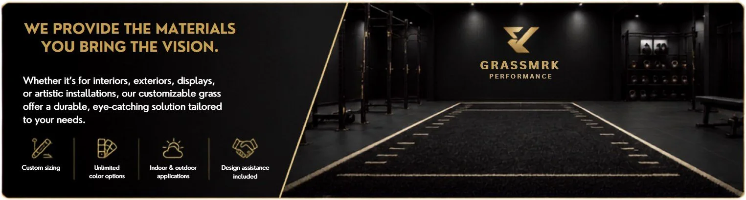 Black gym with gold lettering and accents, featuring a gold logo that reads 'GRASSMRK Performance'. There is a designated workout area with tracks on the floor for activities like sled pushes. The space includes gym equipment and shelving with weights, illuminated by overhead lighting.