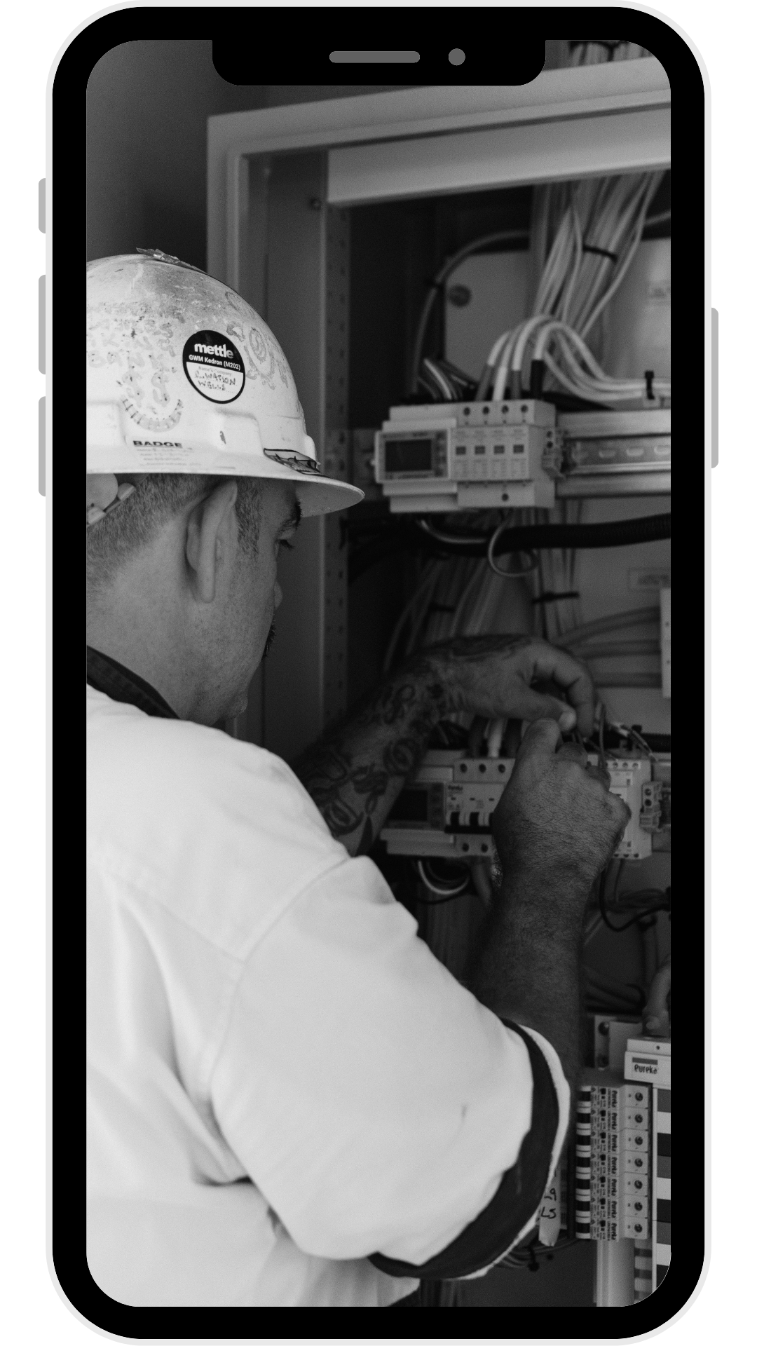 content creation of an electrician working on electrical panel wiring inside a cabinet.