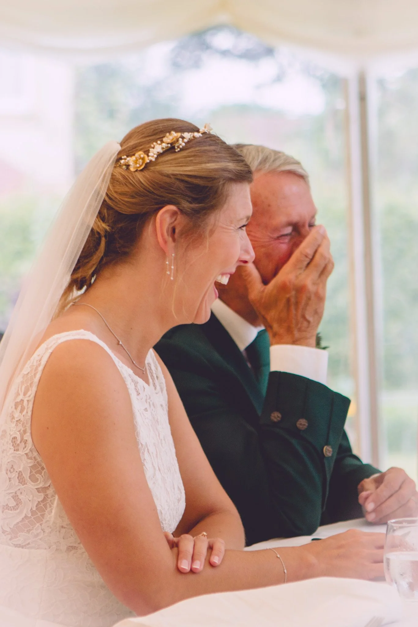 Bride and her dad laughing