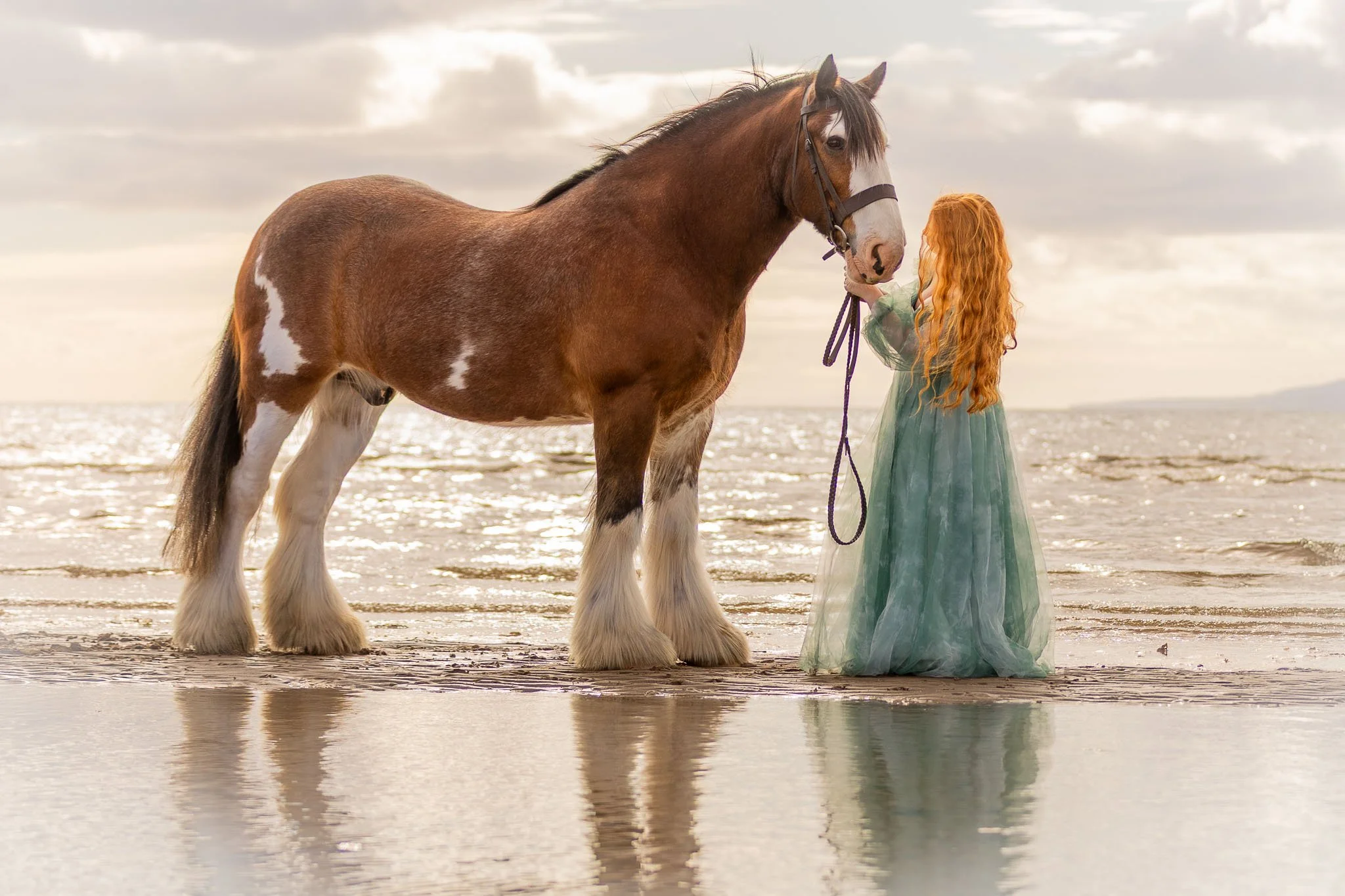 Red haired model and horse at Ayr beach