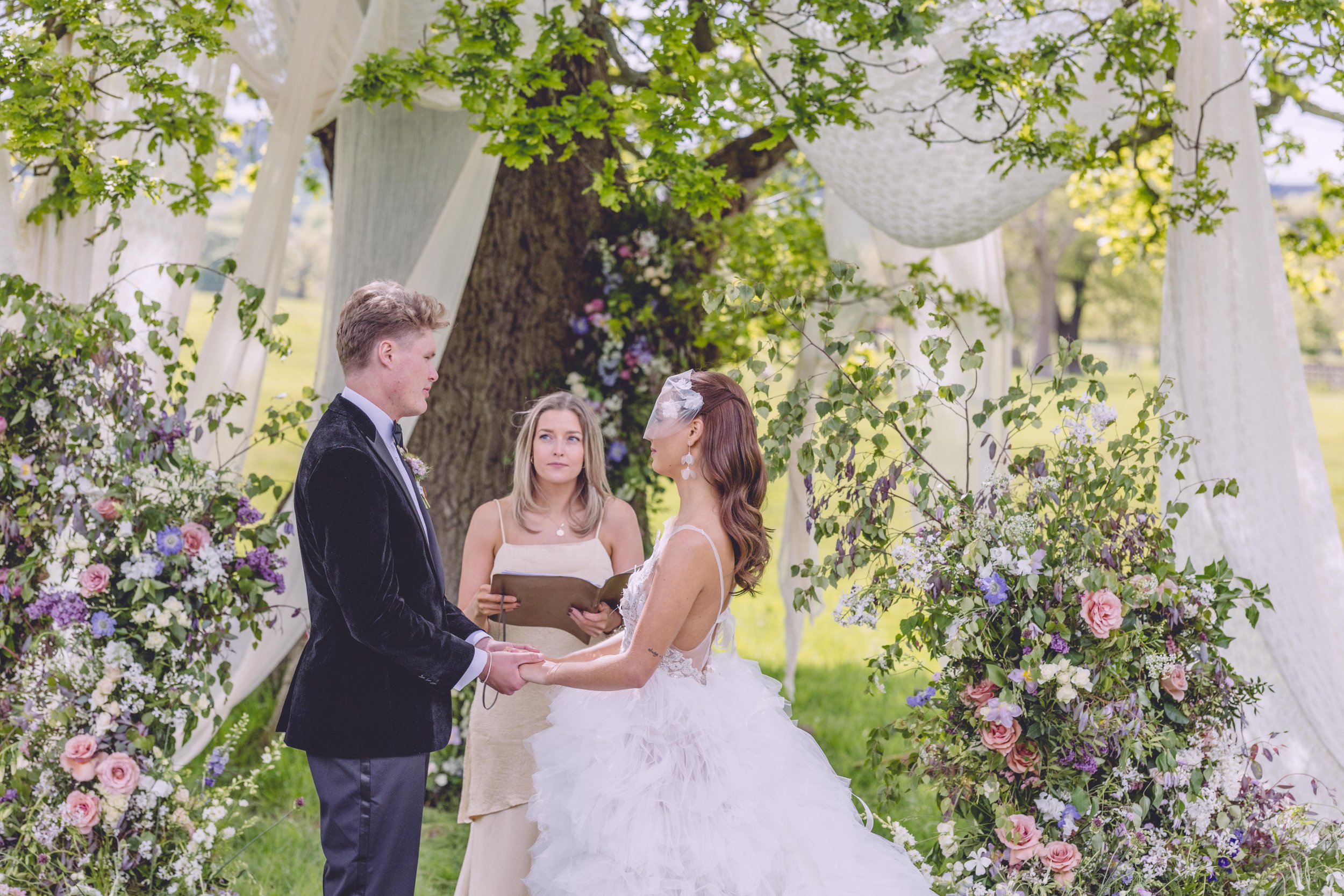 Bride and groom being married by celebrant 