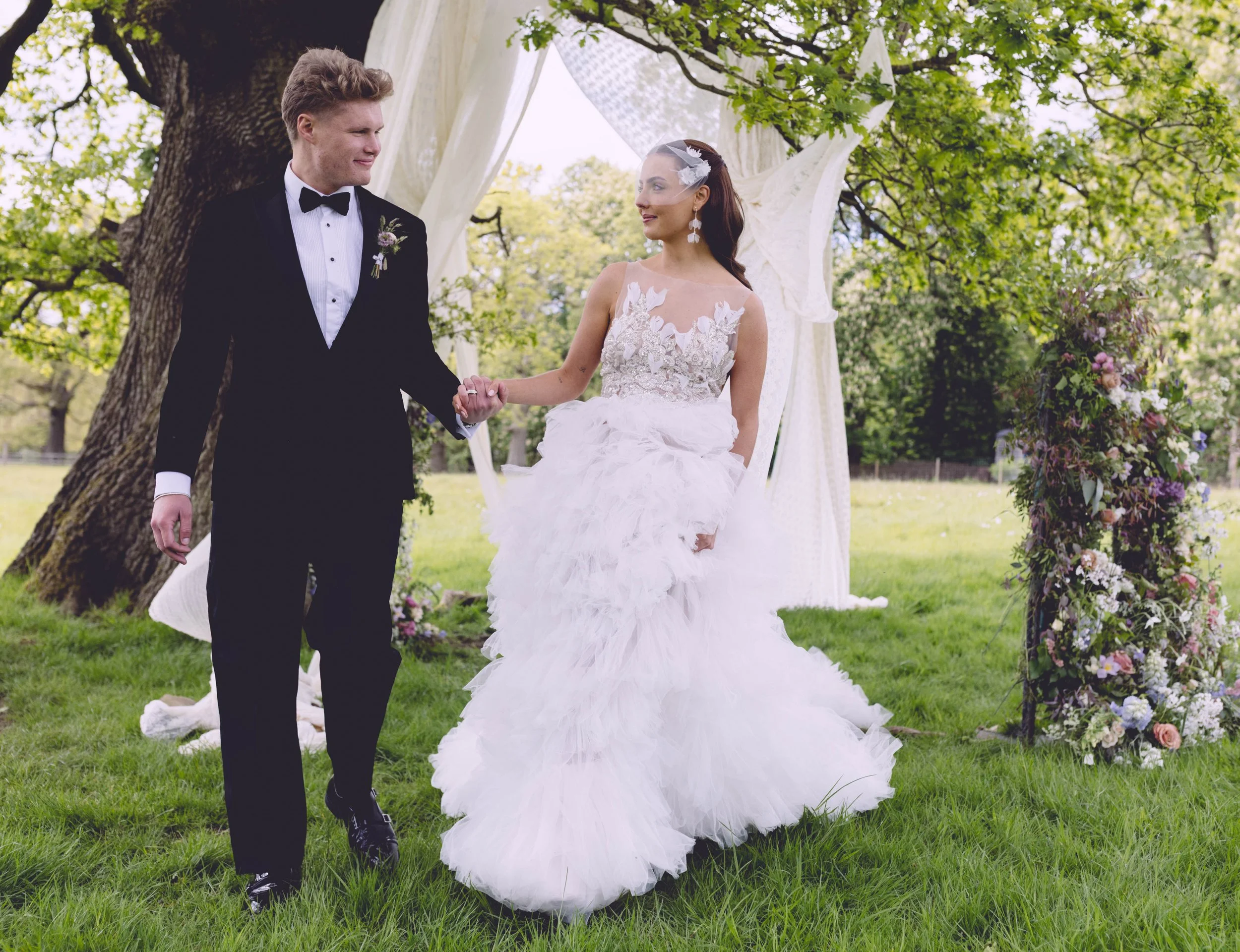 Bride and groom walking away outside having just been married
