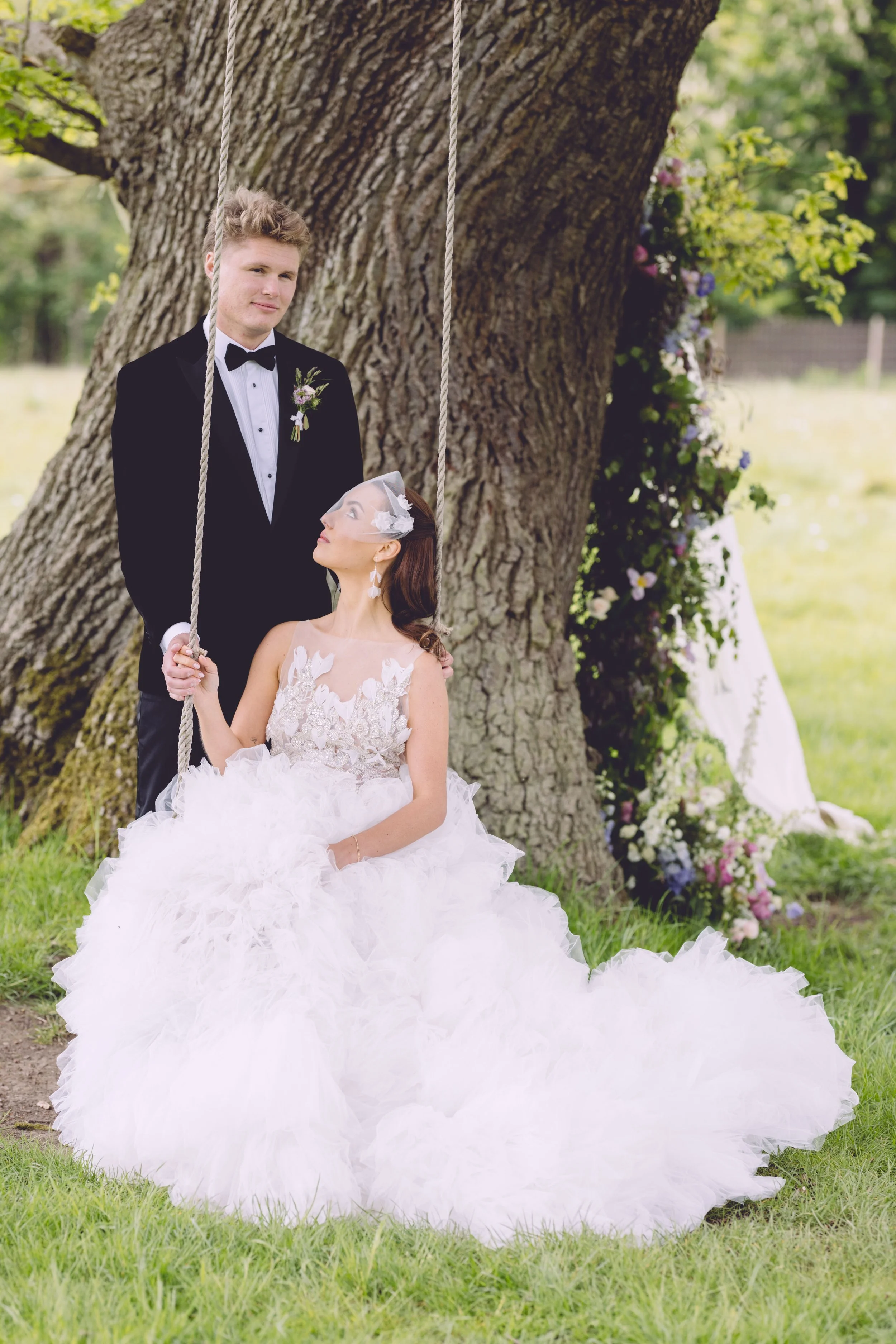 Bride on swing beside her new husband
