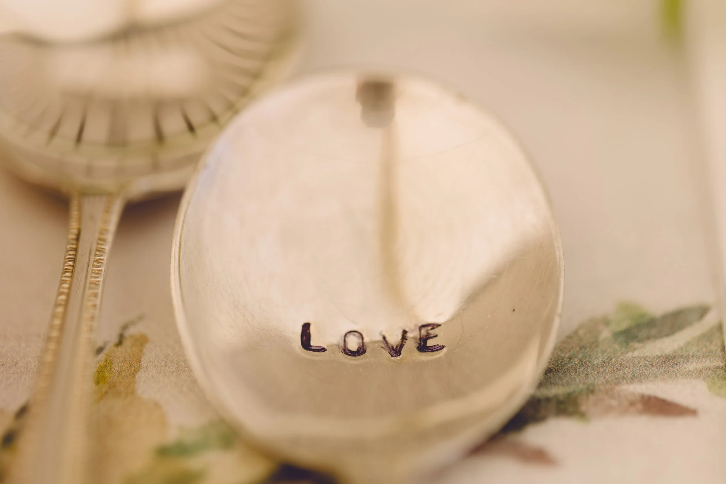 Metal spoon with love written on it