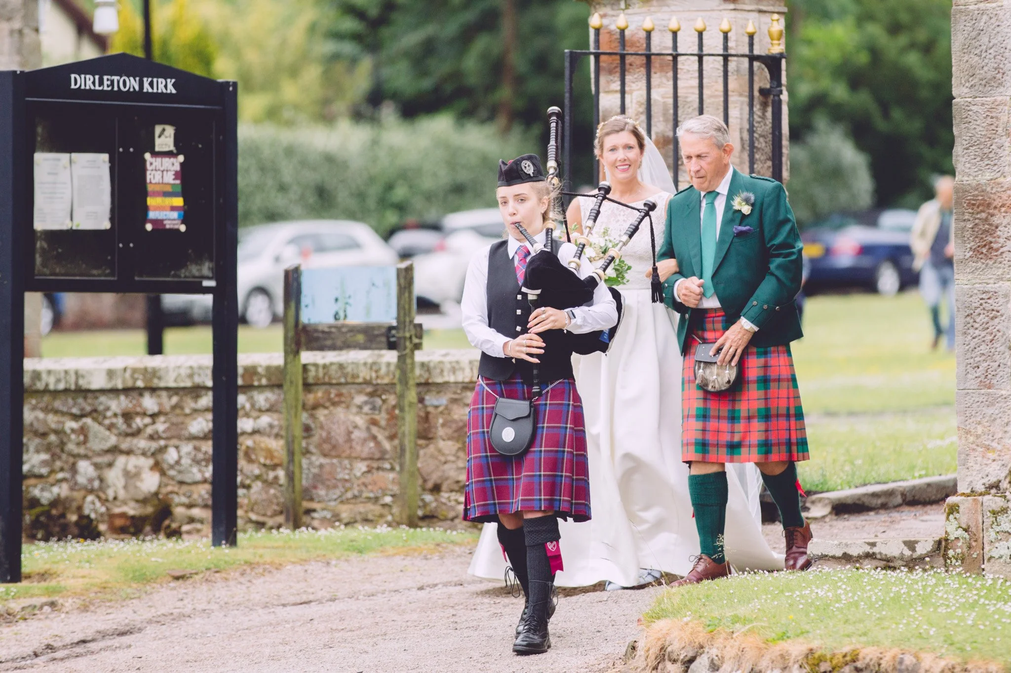 Bride and dad being piped in towards church