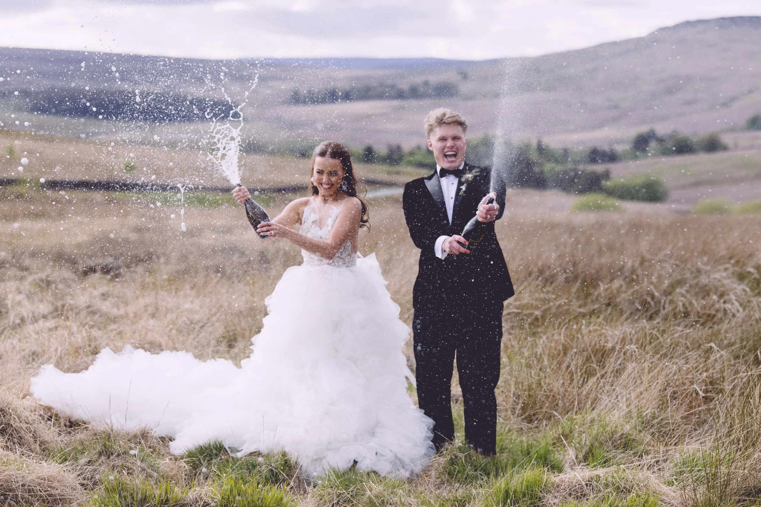Wedding Couple Spraying Champagne