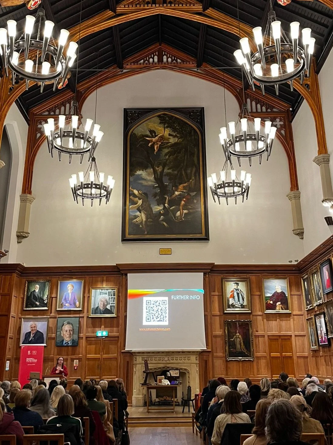 Robyn Atcheson delivering a talk in the Great Hall at Queen's University Belfast to an audience of over one hundred people.