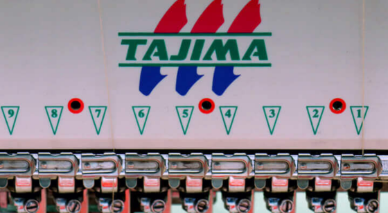 Pool billiards scoring rack with numbered triangular markers and red dots on triangles 4, 7, and 9, with Tajima logo above.