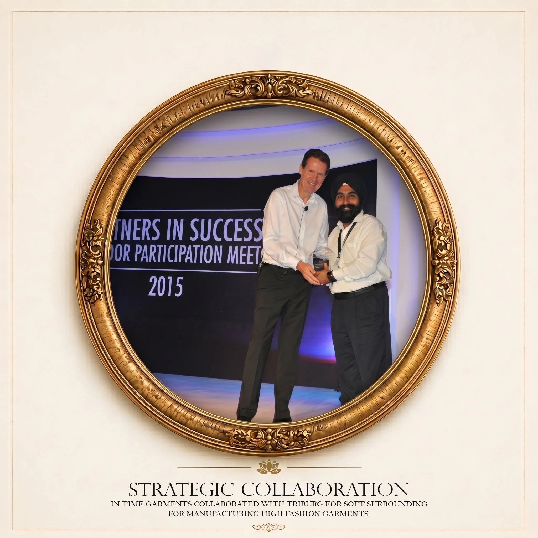 A photo of two men standing inside an ornate, golden frame mirror, shaking hands and smiling. The background shows part of a digital screen displaying text related to a strategic collaboration in the garment industry, dated 2015.