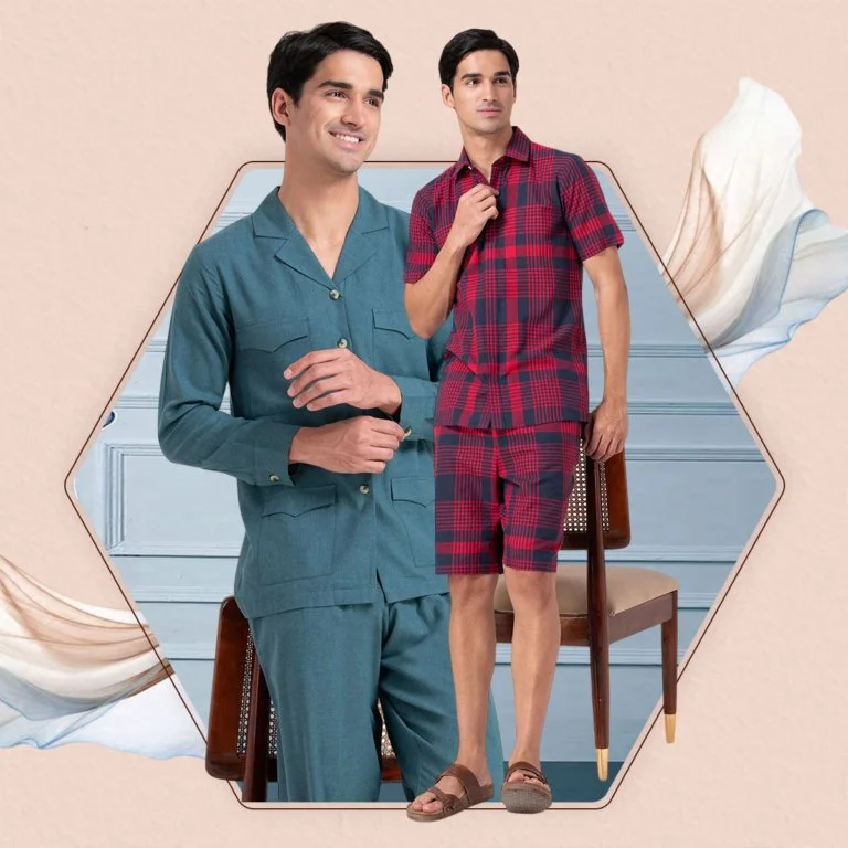 Two men standing in a room, one wearing blue pajamas and the other wearing red plaid pajamas, with one holding a phone and the other holding a bag.