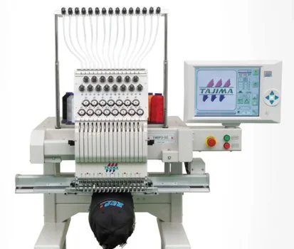 Automated embroidery or sewing machine with digital control panel, multiple thread spools, and embroidery design on display.