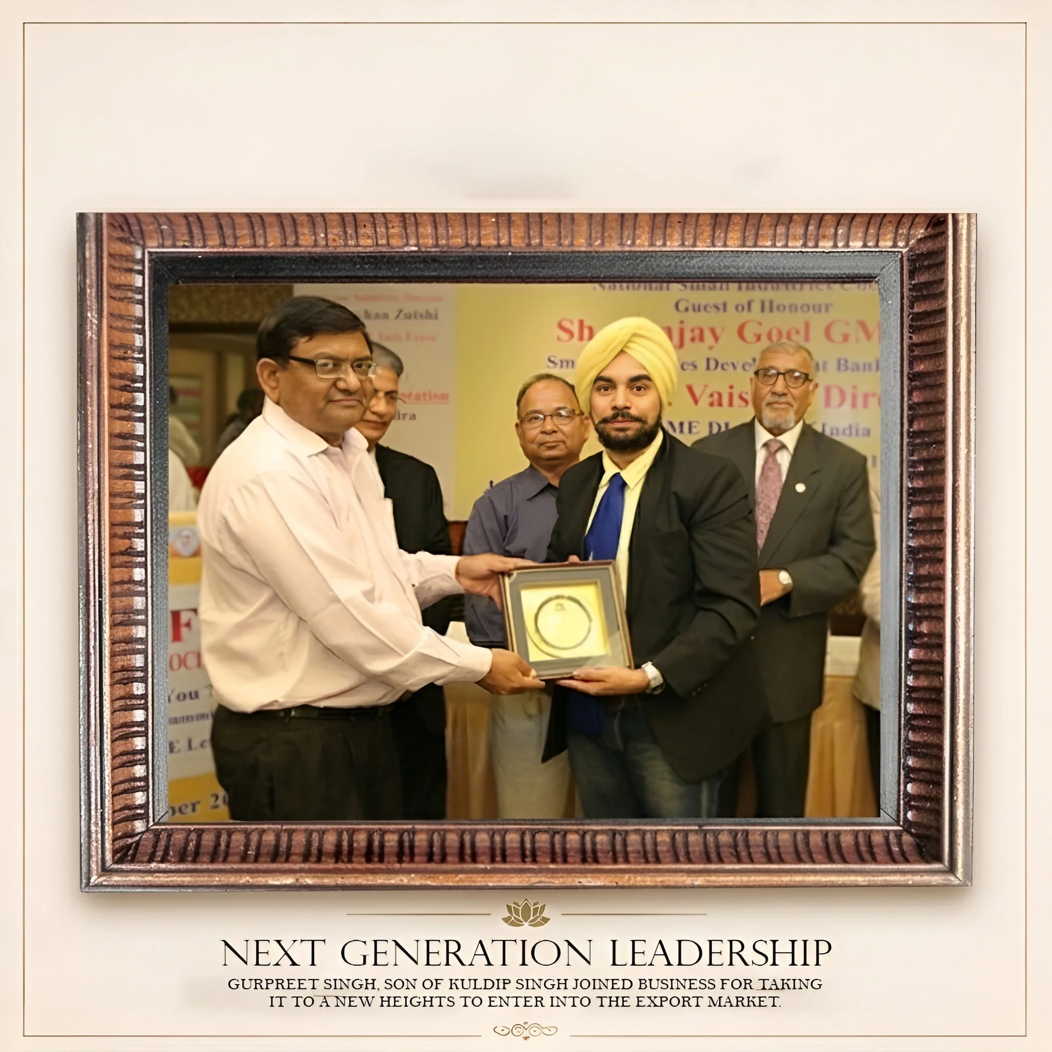 Group of men dressed in formal attire posing together at an event with a banner behind them. One man is holding a framed award or certificate. The setting appears to be an awards ceremony or formal gathering.