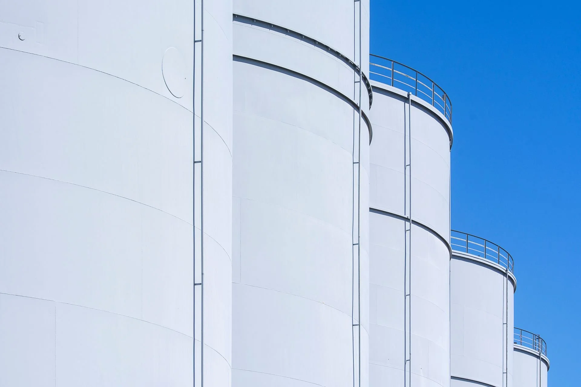 White chemical storage tanks against a blue sky, representing bulk chemical storage in the EU
