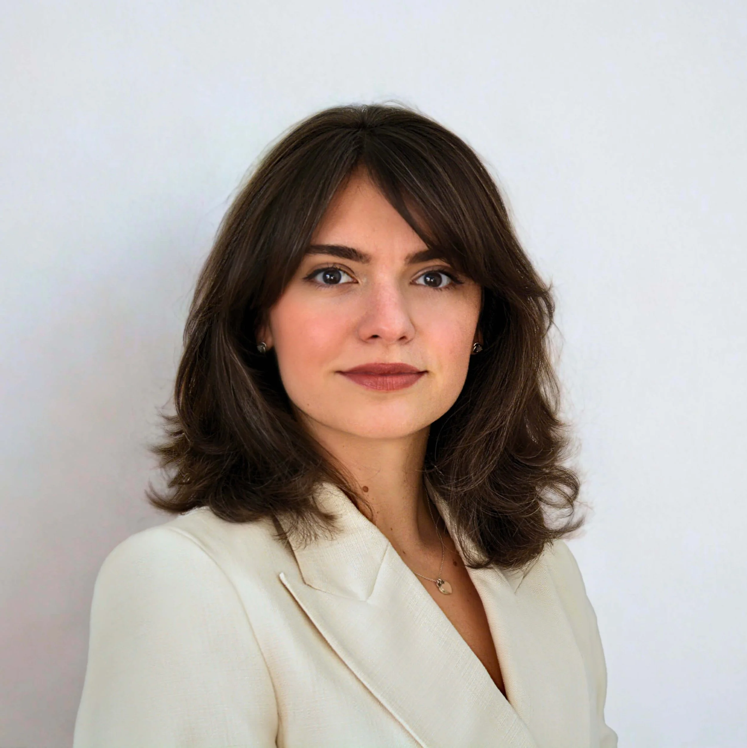Iulia Trandafir, Founder of Rosentell, in a white blazer against a white background.