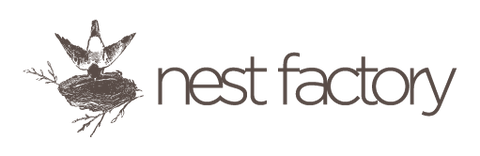 Nest Factory logo with a bird on a branch to the left of the text