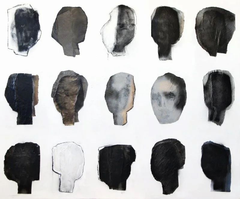 A collection of 15 black and white watercolor paper cutouts of human head profiles arranged in a grid.
