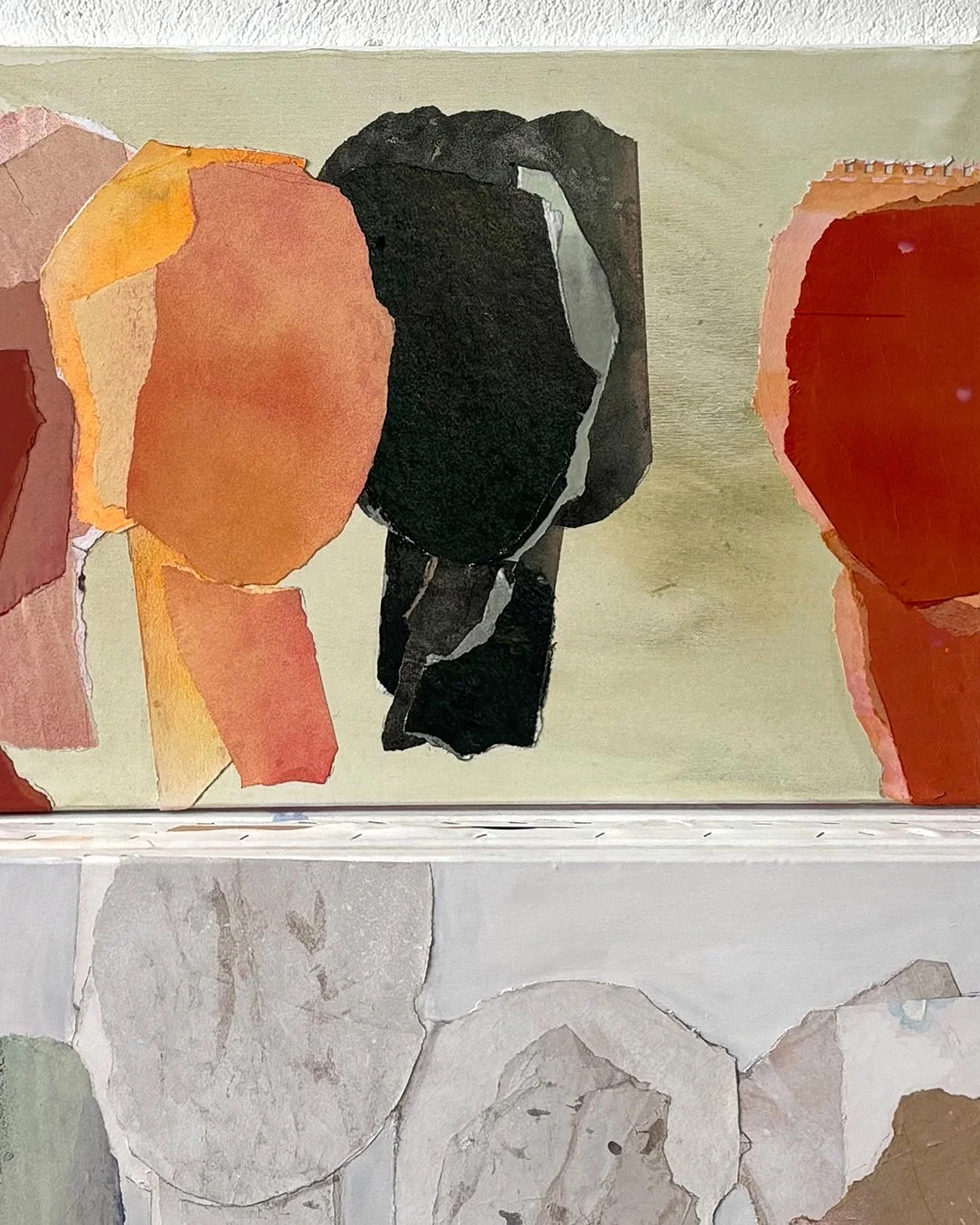 Abstract collage of torn paper and painted paper with geometric and organic shapes in earthy tones of black, orange, red, beige, and gray.