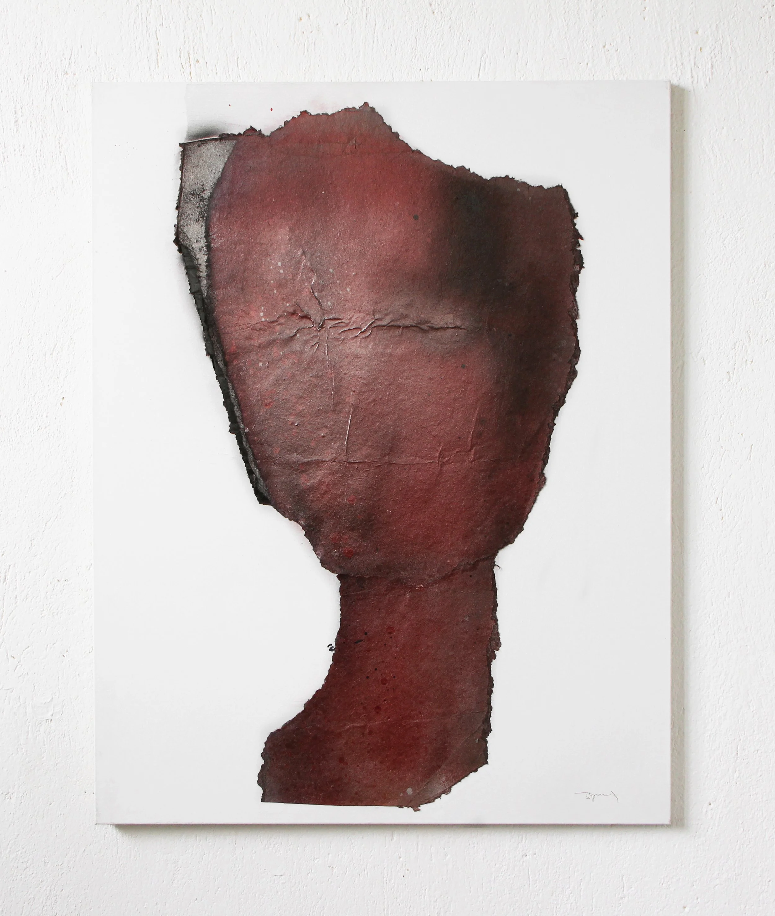 Abstract artwork with torn, dark red paper on a white canvas, creating a profile of a person's face in silhouette.