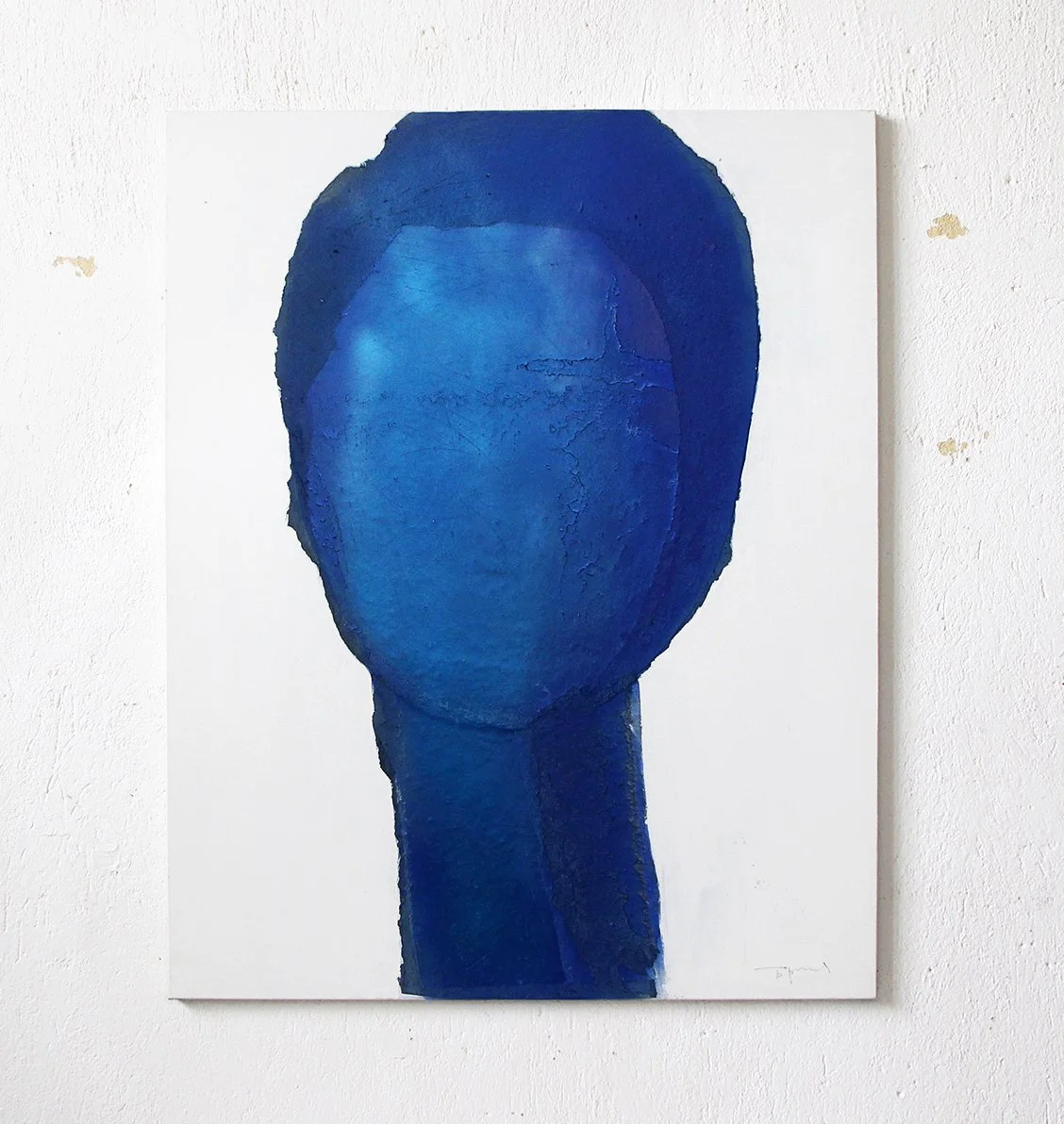 Abstract painting of a faceless figure in shades of blue on a white wall.