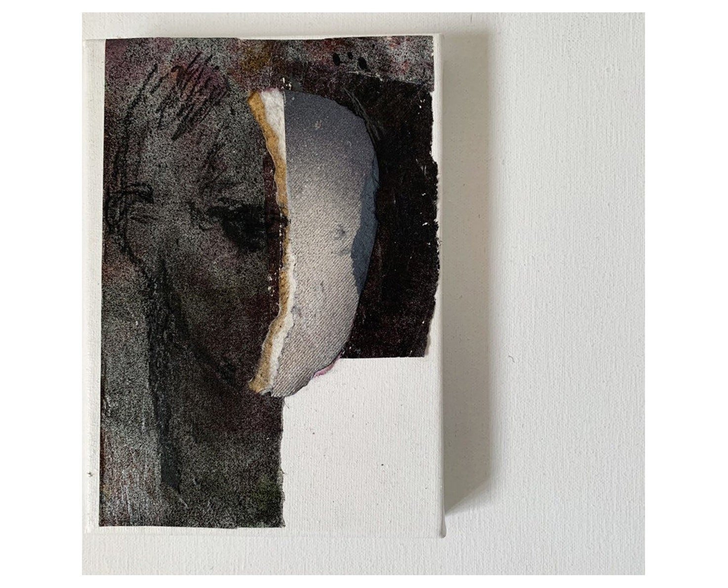 Close-up of a black and white painting of a man, small contemporary artwork in mixed media