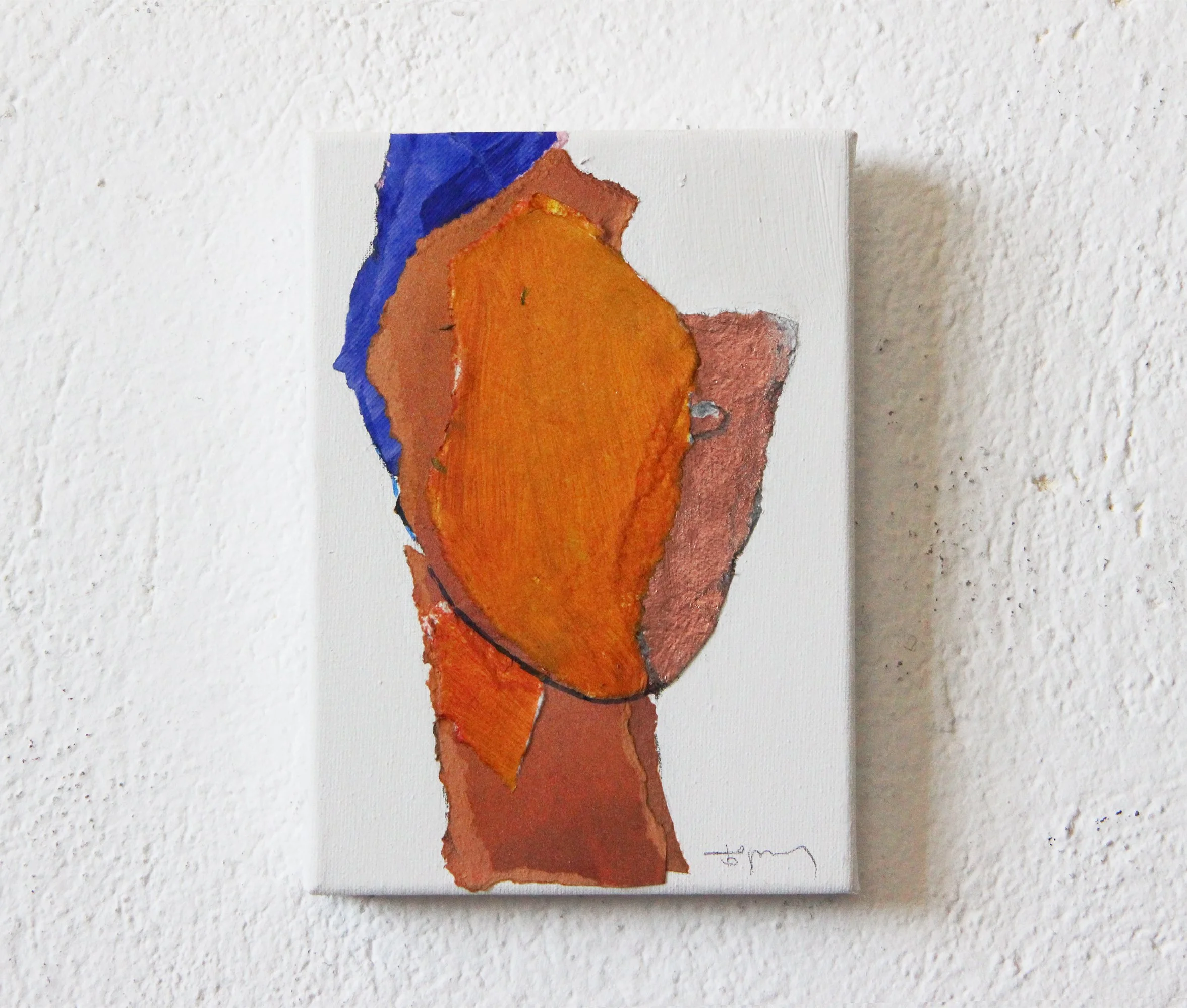 Abstract painting on canvas with warm and cool colors, including orange, blue, and earthy tones, hung on a textured white wall.