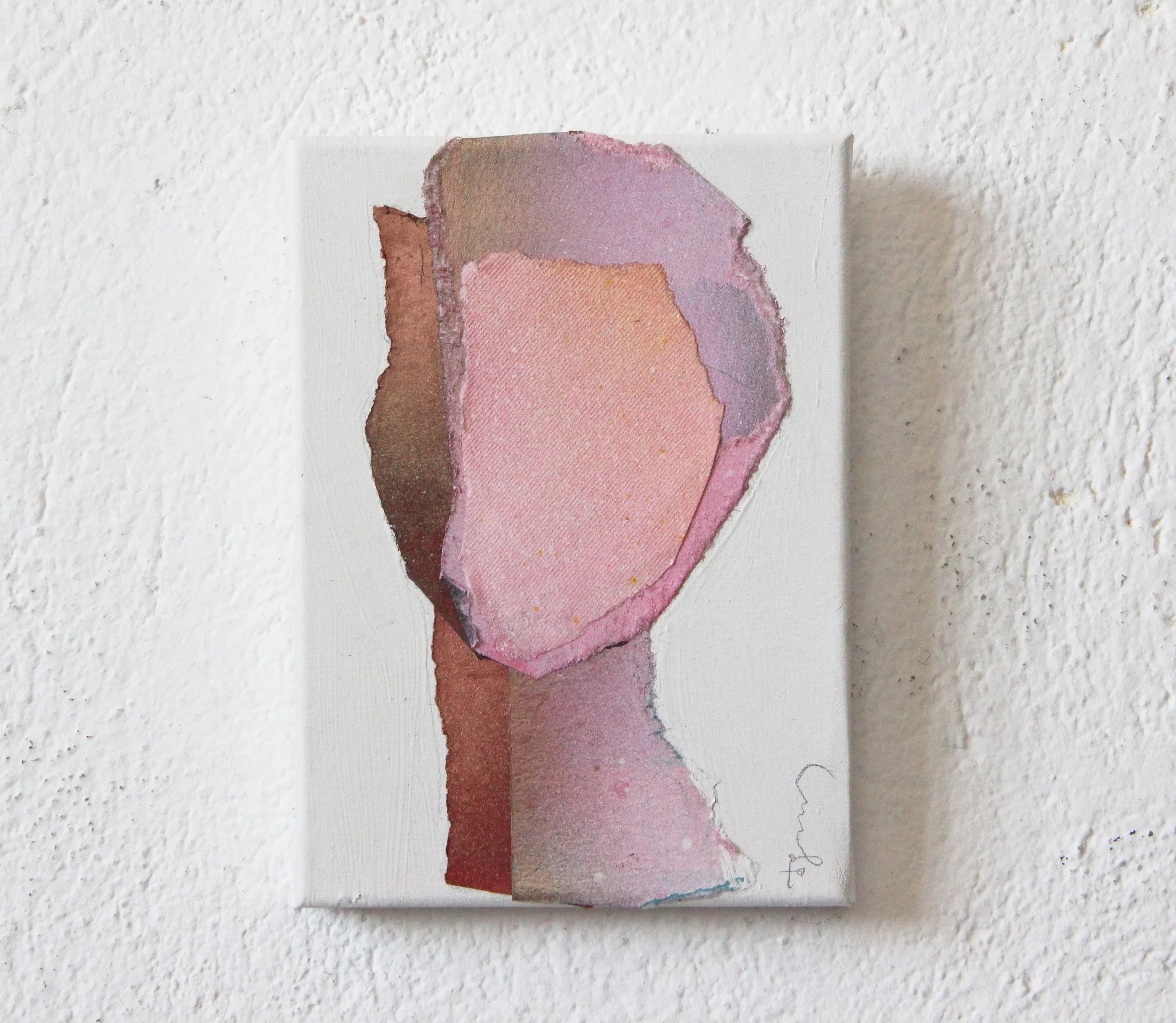 Abstract watercolor painting of a human profile silhouette with soft pink, purple, and brown tones, mounted on a white wall.