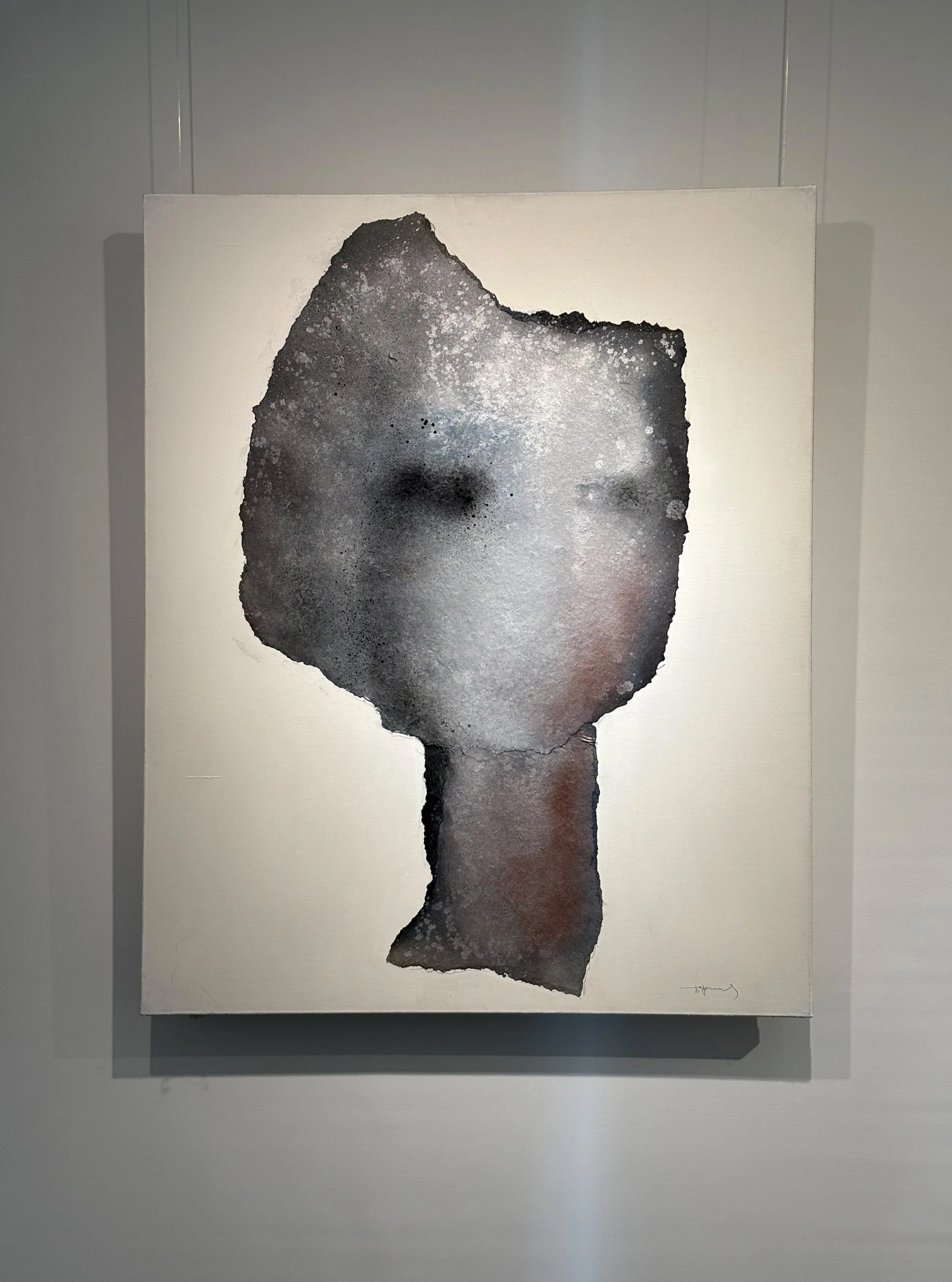 Contemporary abstract portrait of a face on a canvas, blending dark and light tones with a textured appearance.