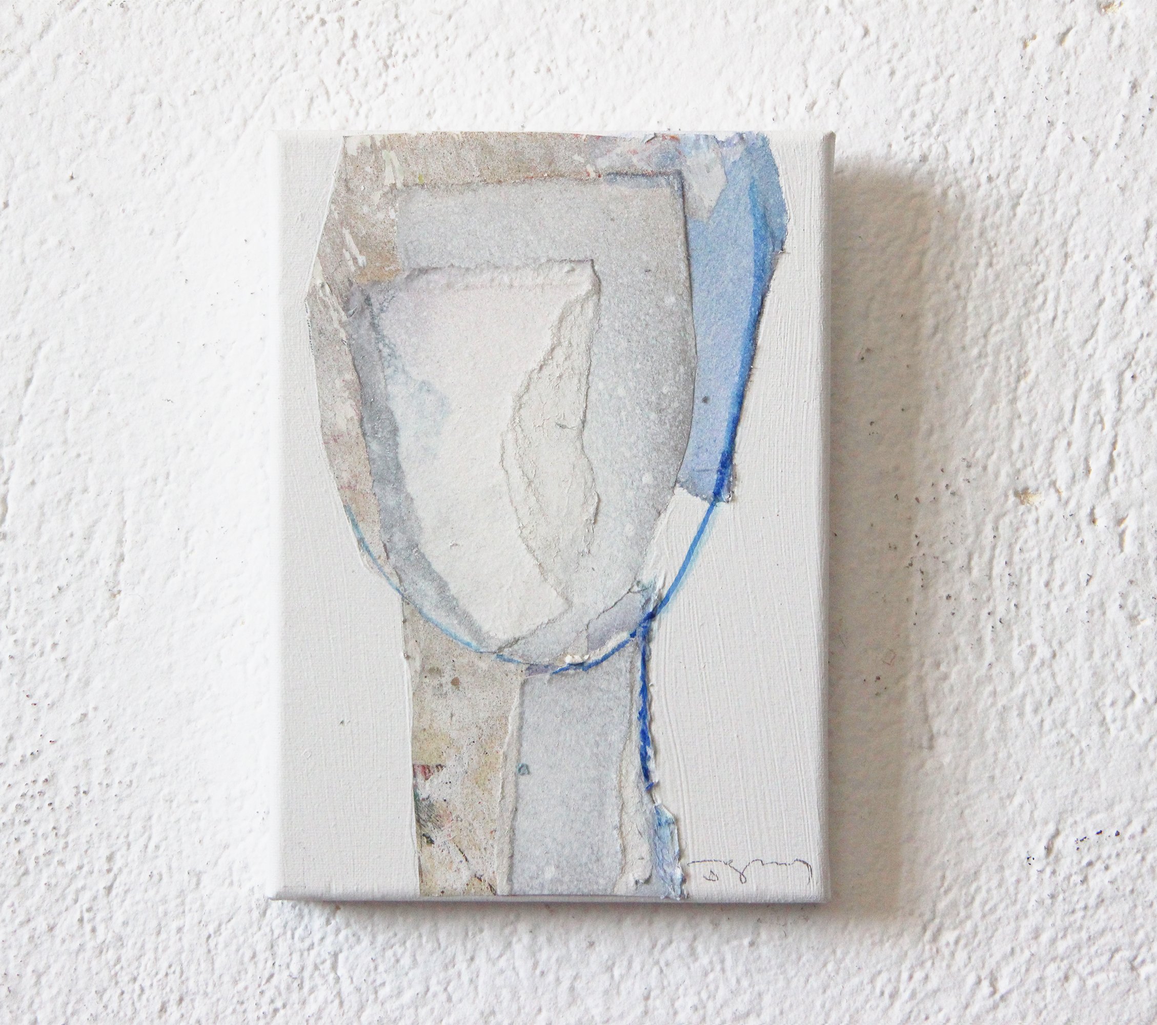 Abstract mixed media artwork on canvas, featuring a shield-like shape outlined in black and blue lines, with textured and layered surface in neutral tones, hung on a white textured wall.