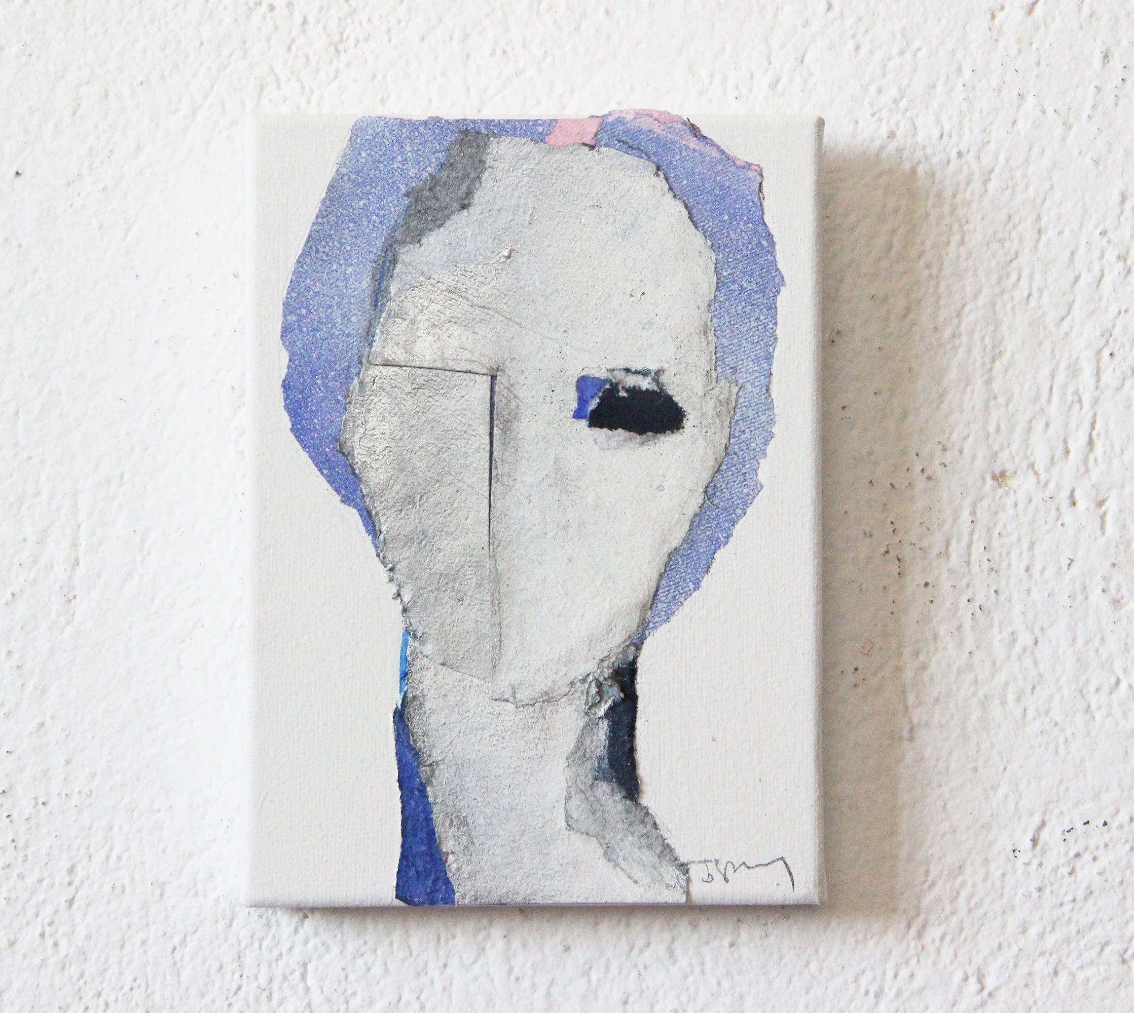 Abstract portrait painting of a person with a textured, fragmented face, blue and silver color accents, on a white textured wall.