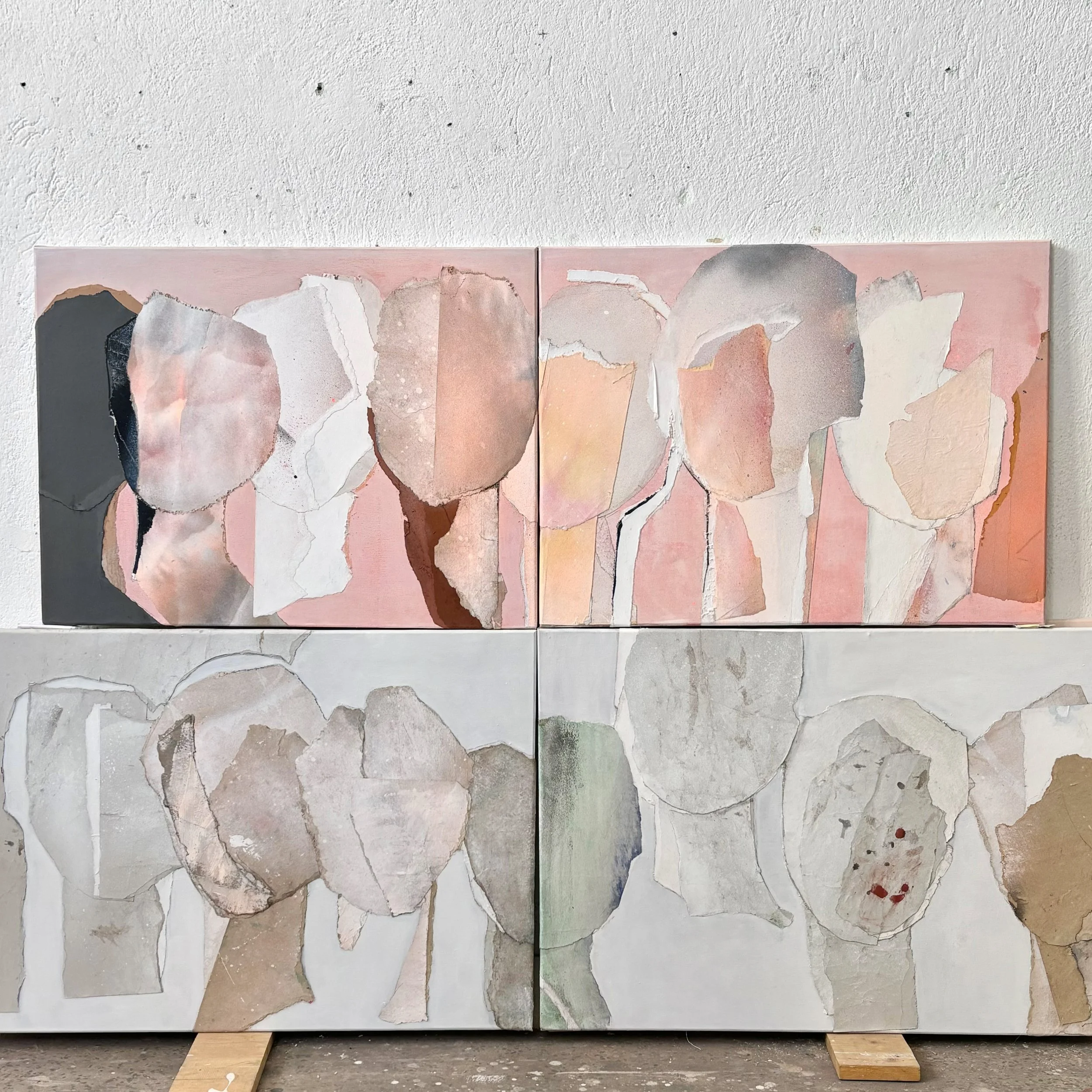 Abstract painting with torn paper shapes in pastel pink, beige, and gray hues arranged on a white and pink background.