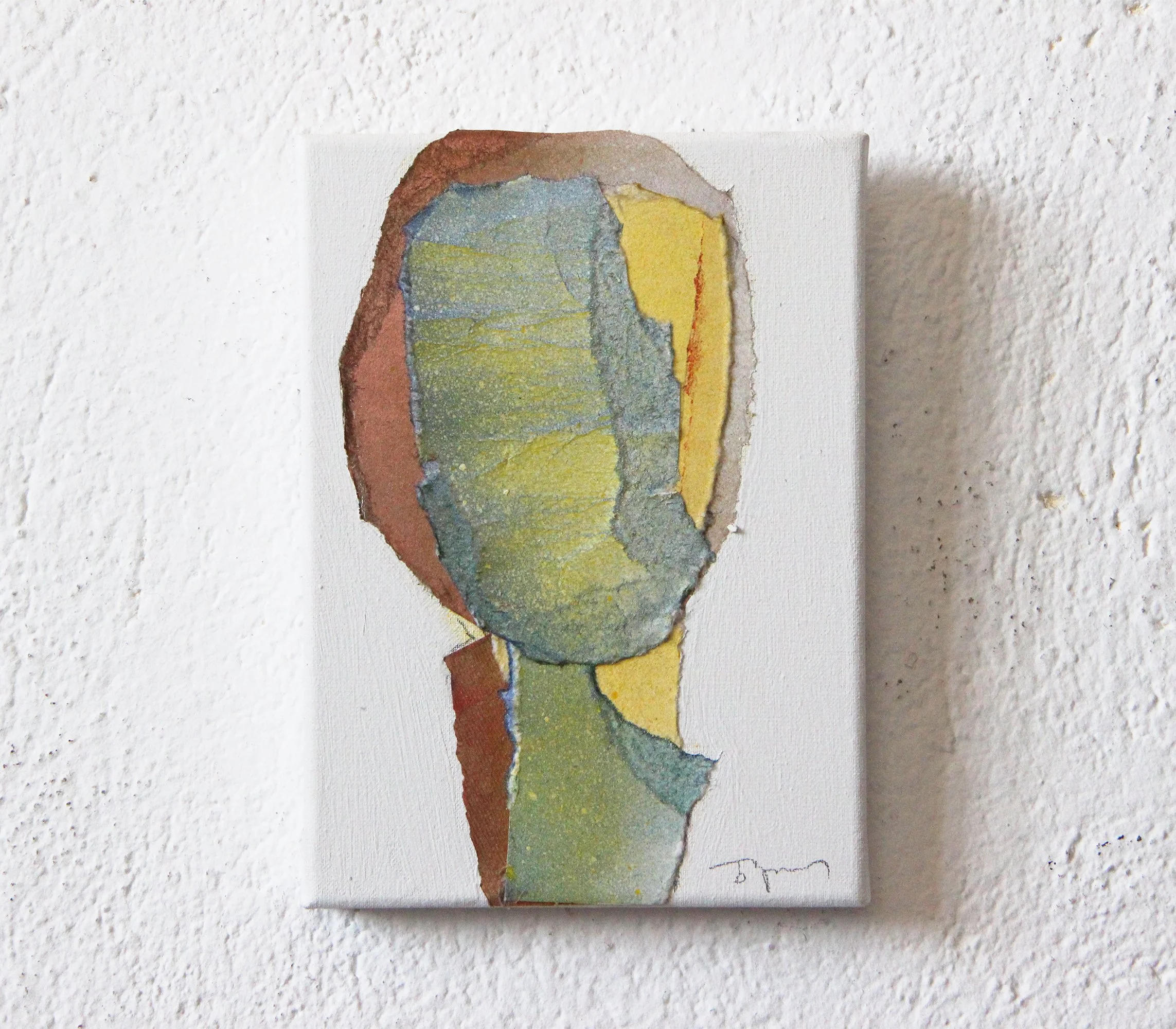 Abstract watercolor painting of a faceless person on a small canvas, hung on a white textured wall.