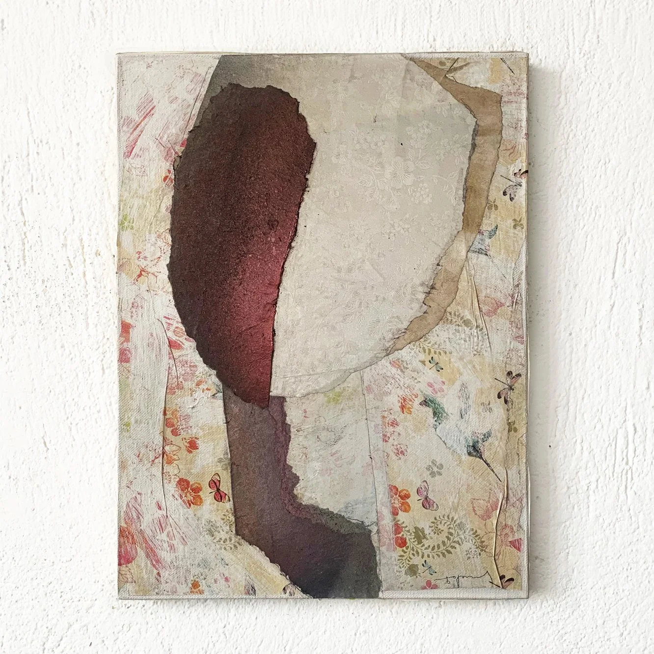 Abstract mixed media art piece with textured shapes and floral paper background.