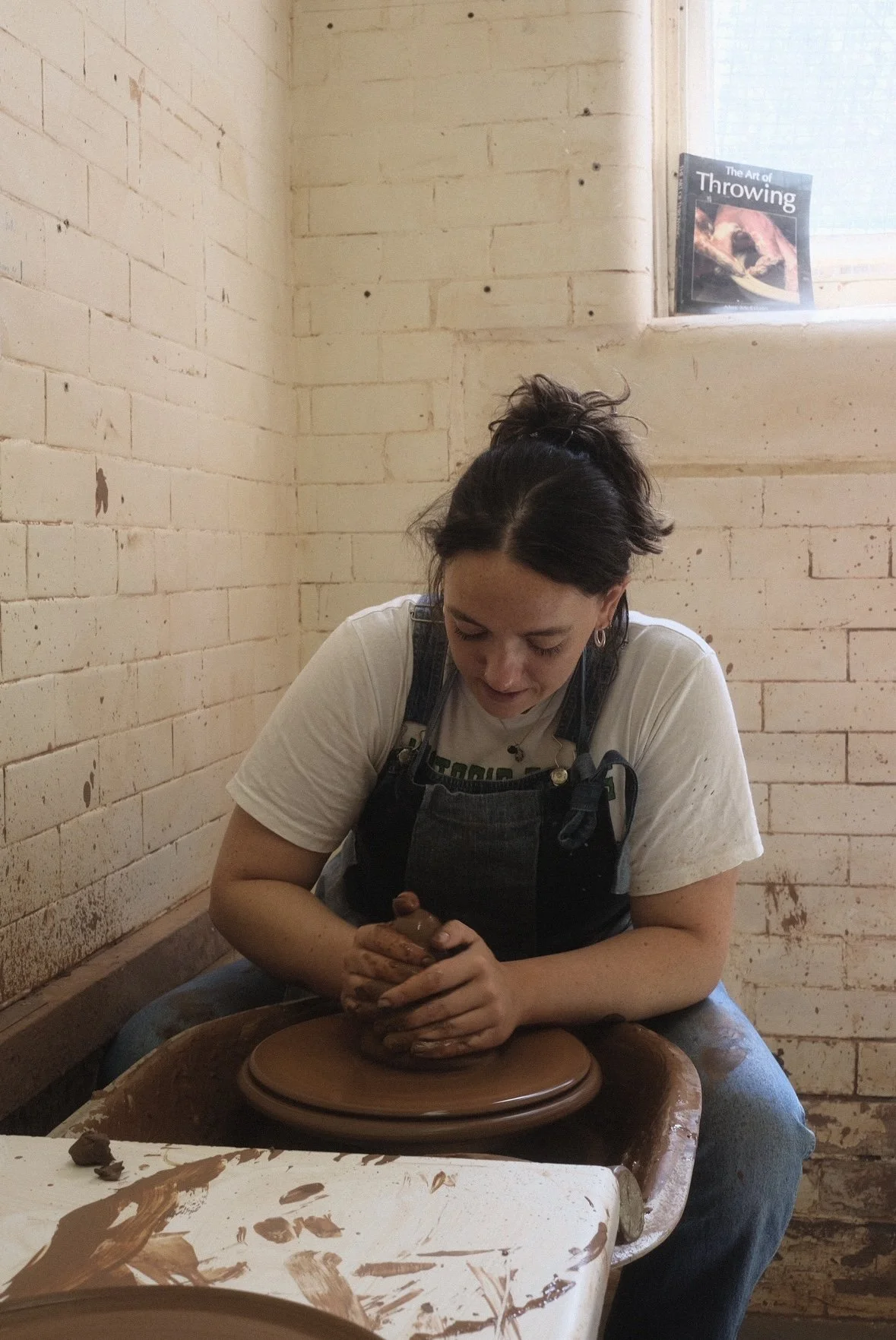 Image of Molly Pilkington throwing on a pottery wheel