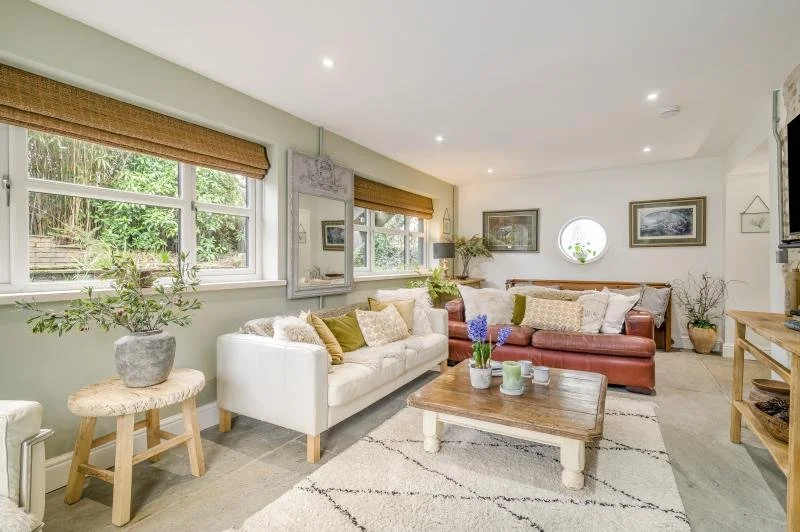 Living room with plenty of comfy seating including TV with Netflix