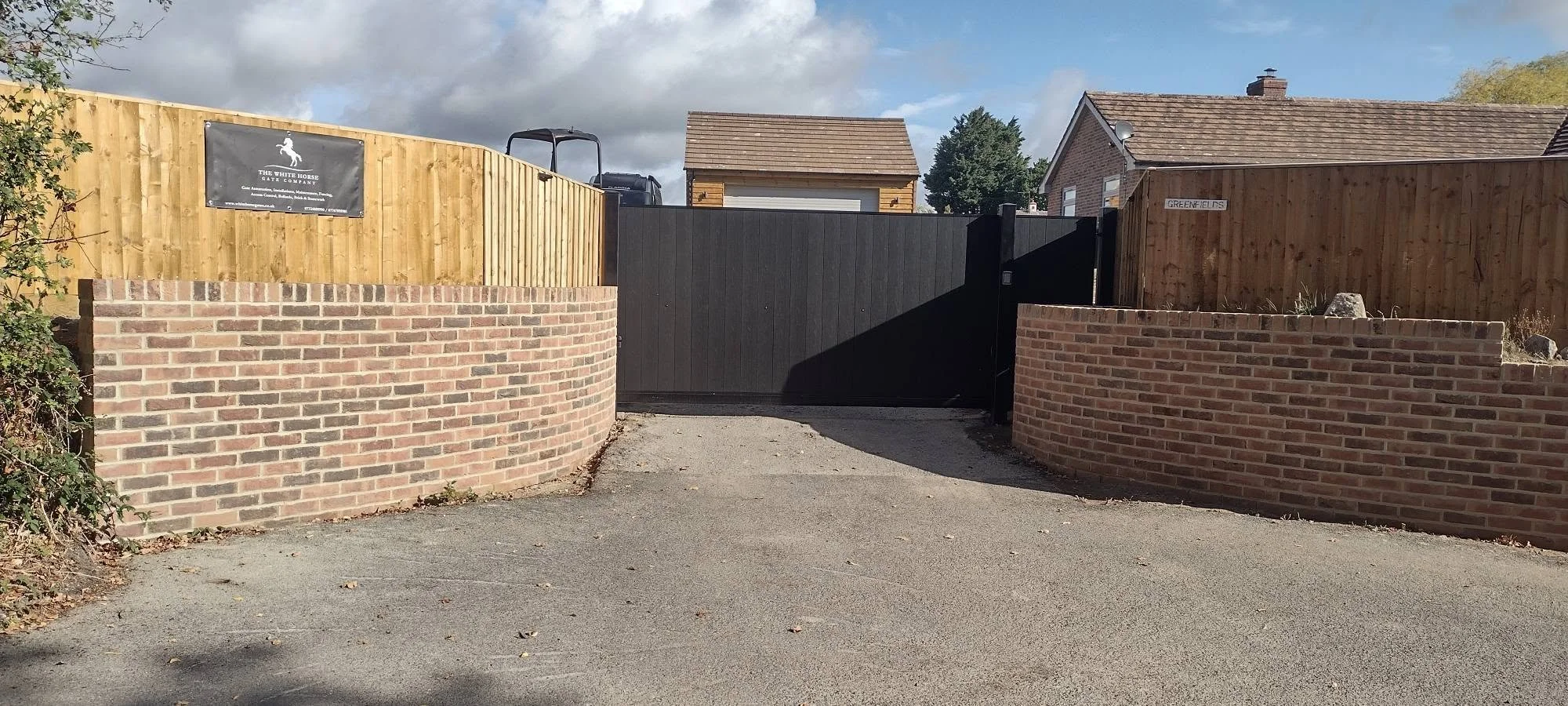 Sliding and a pedestrian gates in Burbage finished in Ebony black cladding.