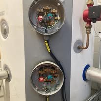 Open electrical panel with visible wiring and circuit boards.