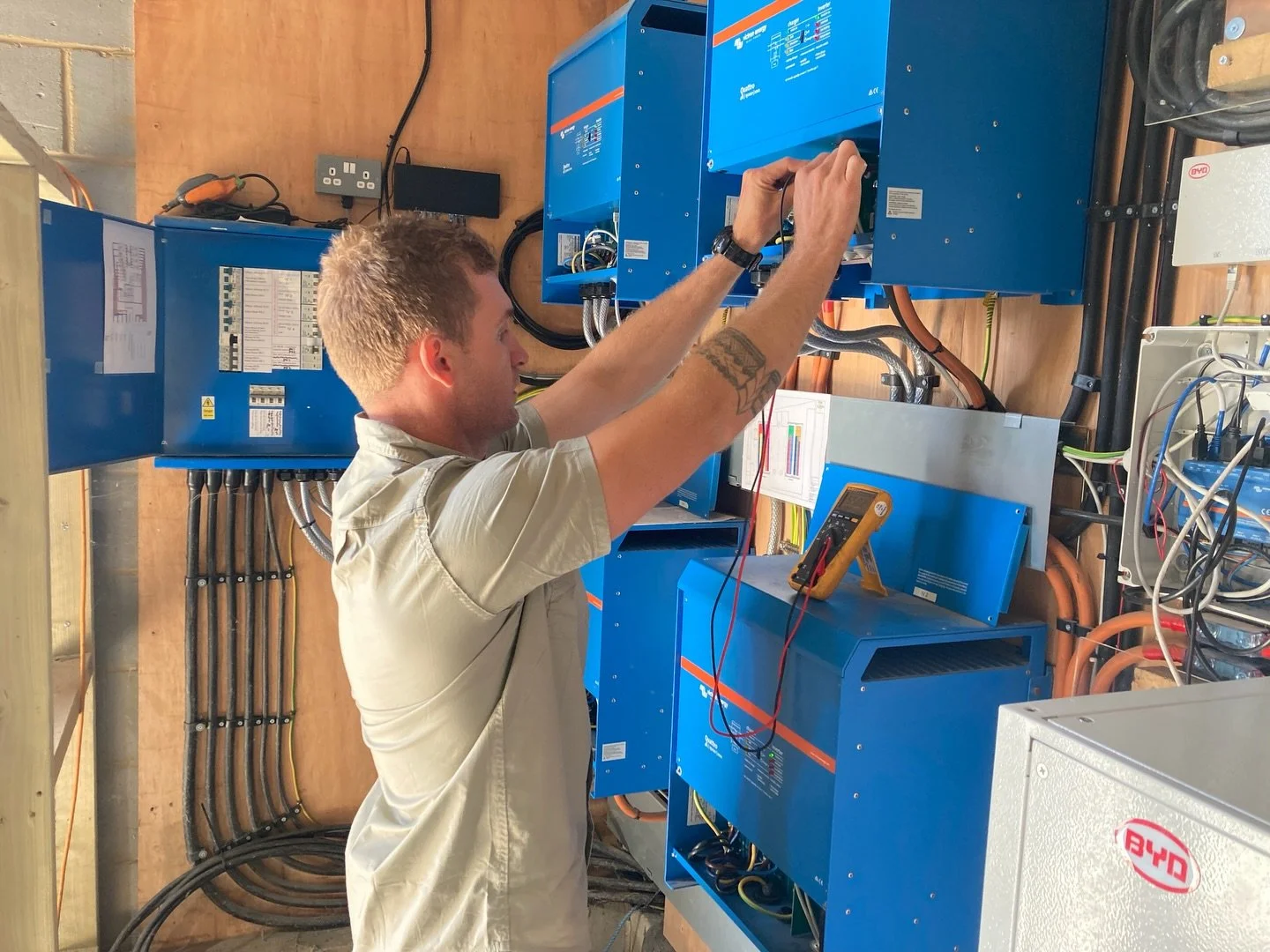 4x 12KW Victron Quattro Inverter Chargers in parallel, 154kwh(3000Ah) BYD batteries, 4x RS450/200 solar charger for the 45,600kw of solar in East/West layout, 60KVA Generator backup for entire system and farm. This runs the farm house, plant room, po