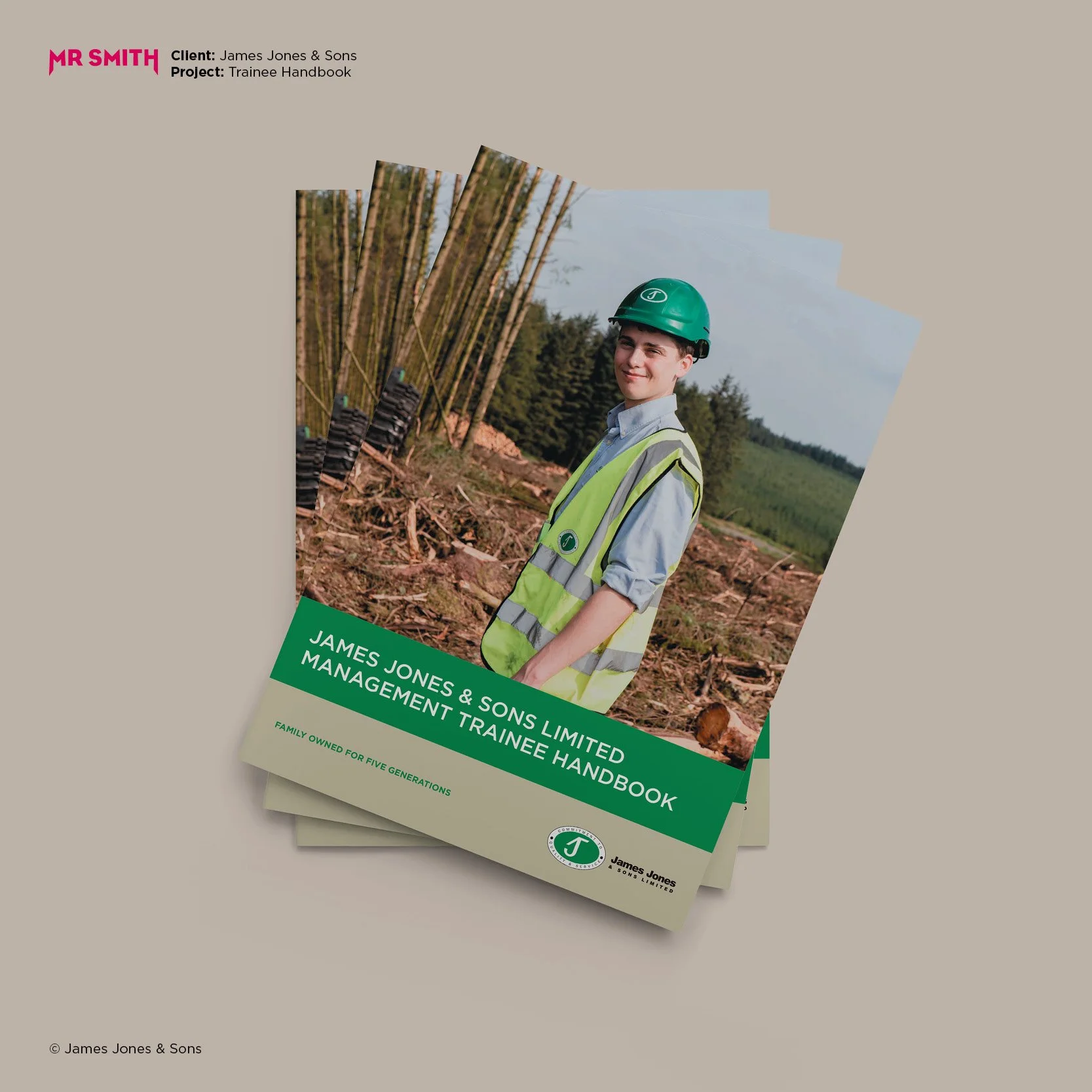 Book titled 'James Jones & Sons Limited Management Trainee Handbook' with a cover photo of a young man wearing a green safety helmet and vest, standing outdoors near a tree plantation.